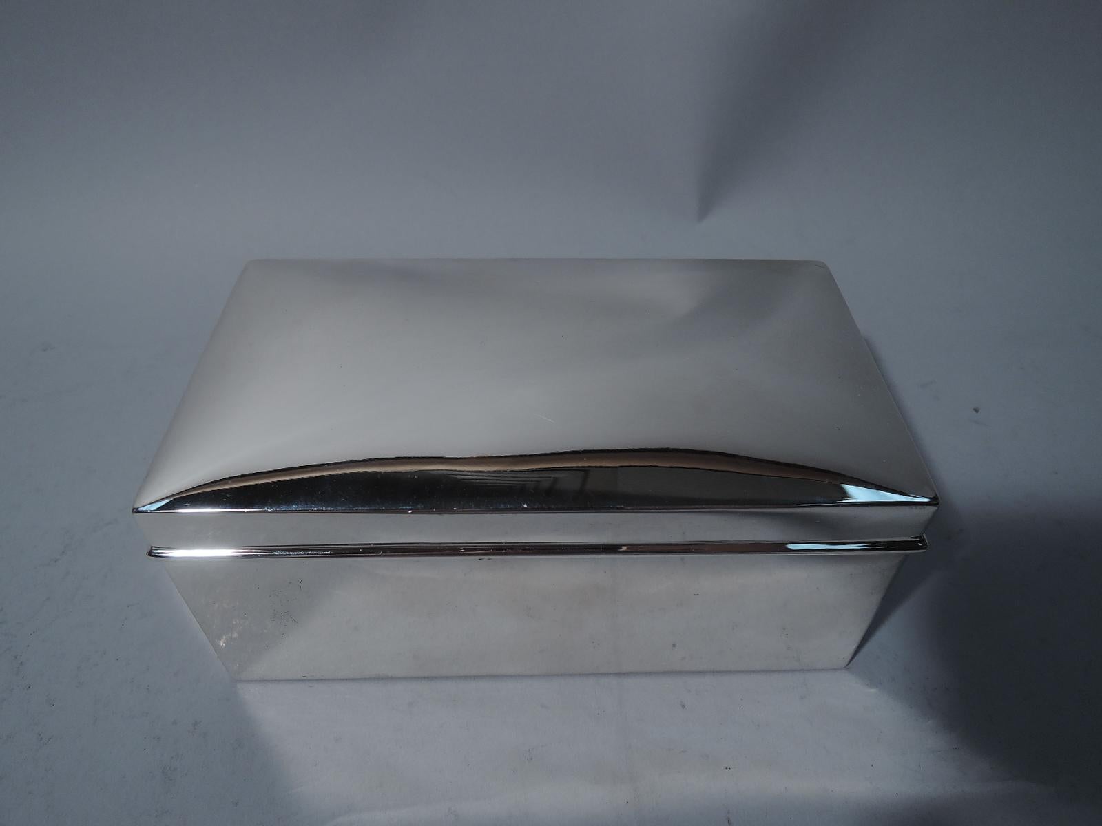 Modern sterling silver casket box. Made by Woods & Chatellier for Tiffany & Co., both in New York. Rectangular with straight sides. Cover is hinged with gently curved top and molded rim. Box and cover interior cedar-lined. Hallmark includes maker's