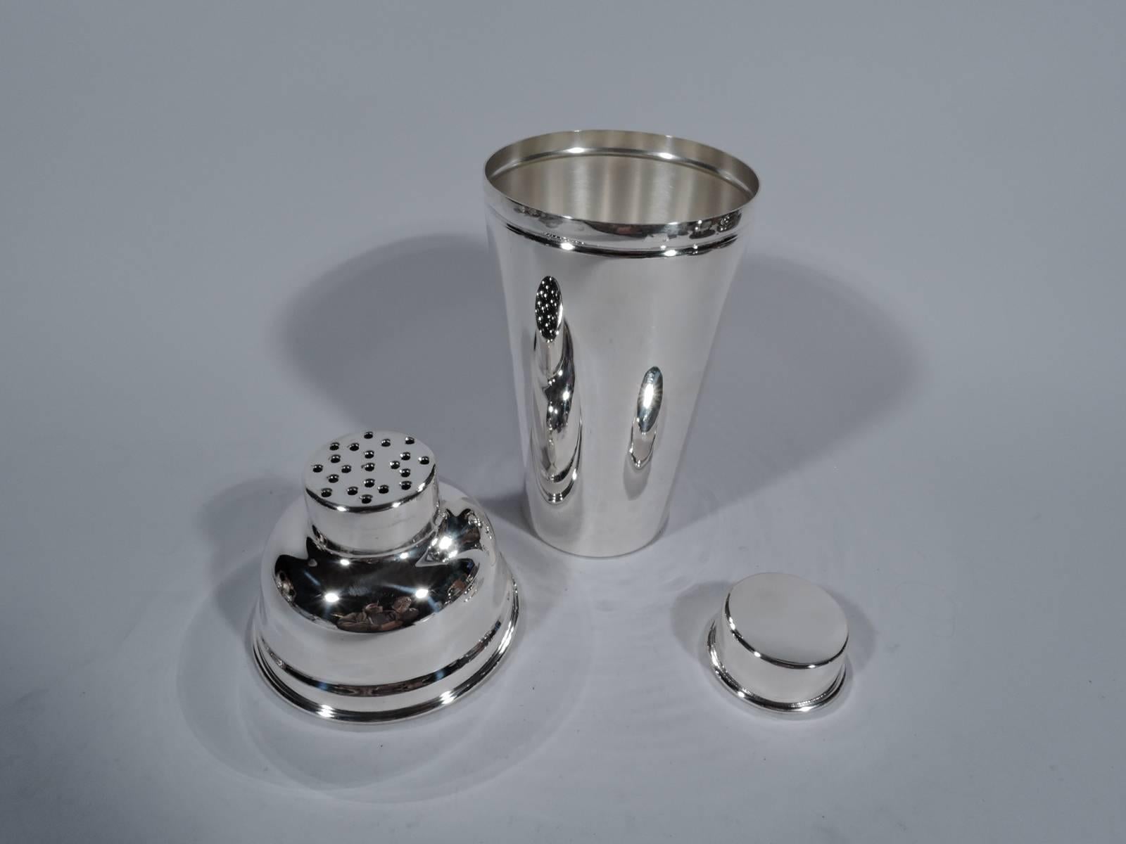 American Modern sterling silver cocktail Shaker. Straight and tapering sides surmounted by dome with short neck and snug CAP. Mouth has pierced built-in strainer. Hallmarked Manchester, a twentieth-century Providence maker. Hallmark includes no.