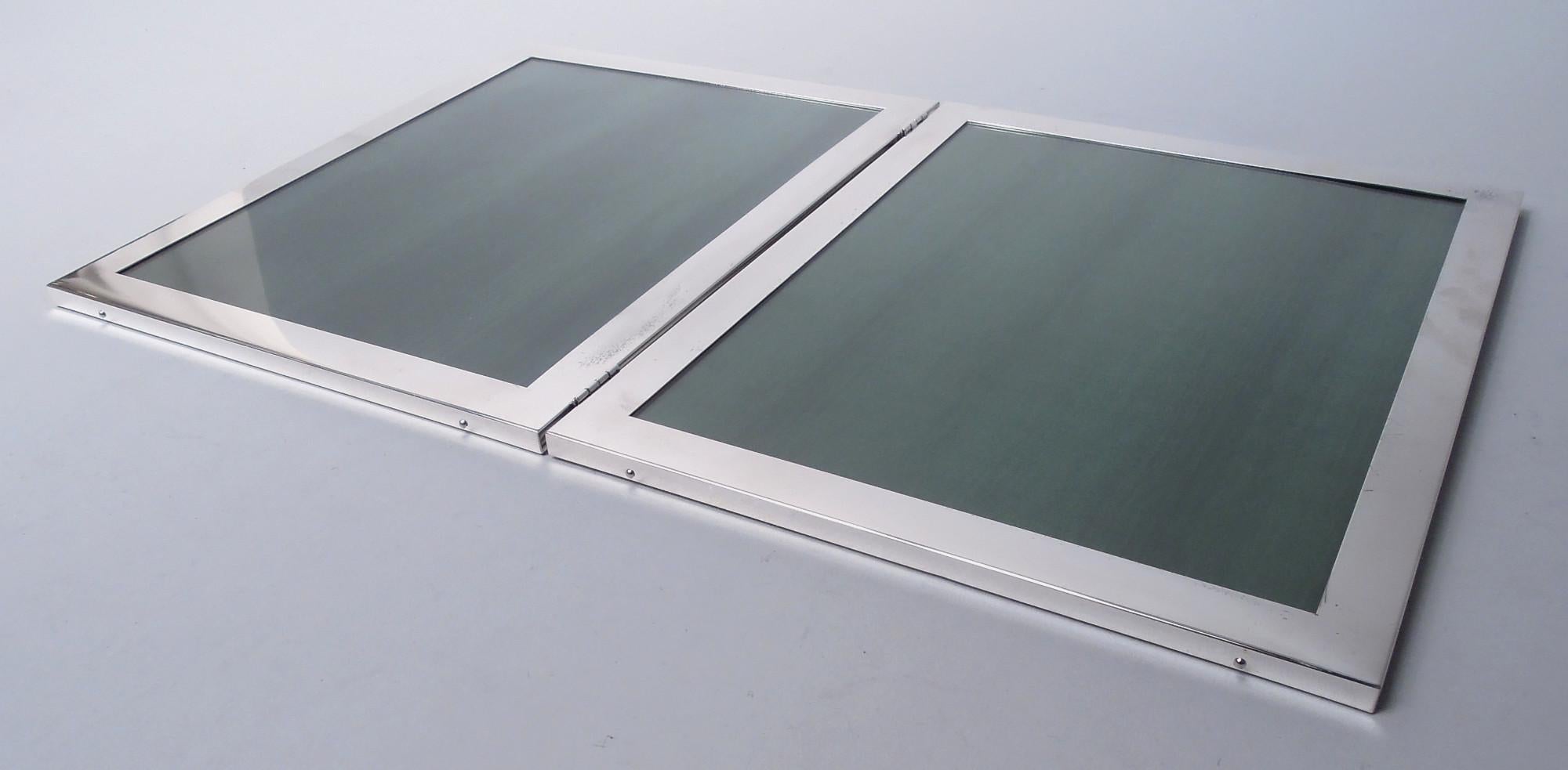 Modern sterling silver hinged double picture frame. Each: Rectangular window in plain and flat surround. With glass, silk lining, and velvet back. Fully marked including stamp for Web Silver Co., a Philadelphia maker active from the 1950s to 1970s.
