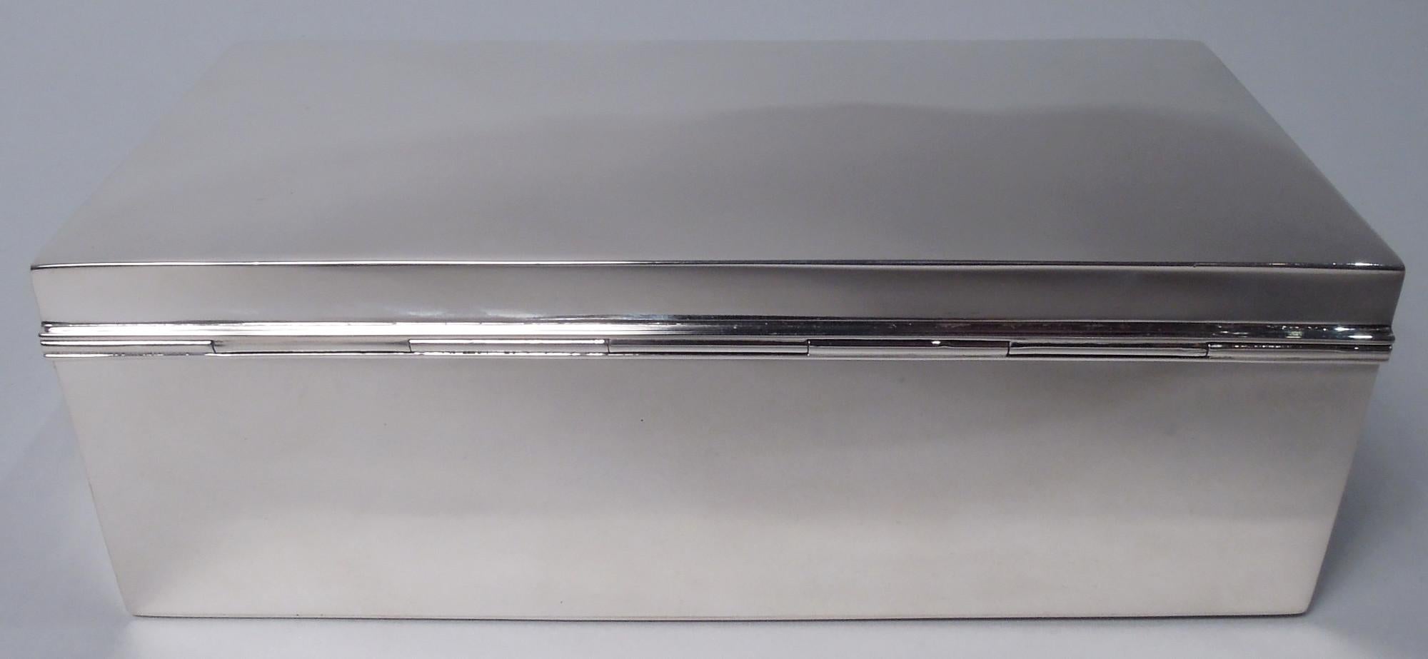 Modern sterling silver jewelry box. Made by Watrous Mfg. Co. (part of International) in Wallingford, Conn., ca 1950. Rectangular with straight sides. Cover hinged and tabbed with gently curved top. Velvet-lined interior. Fully marked including