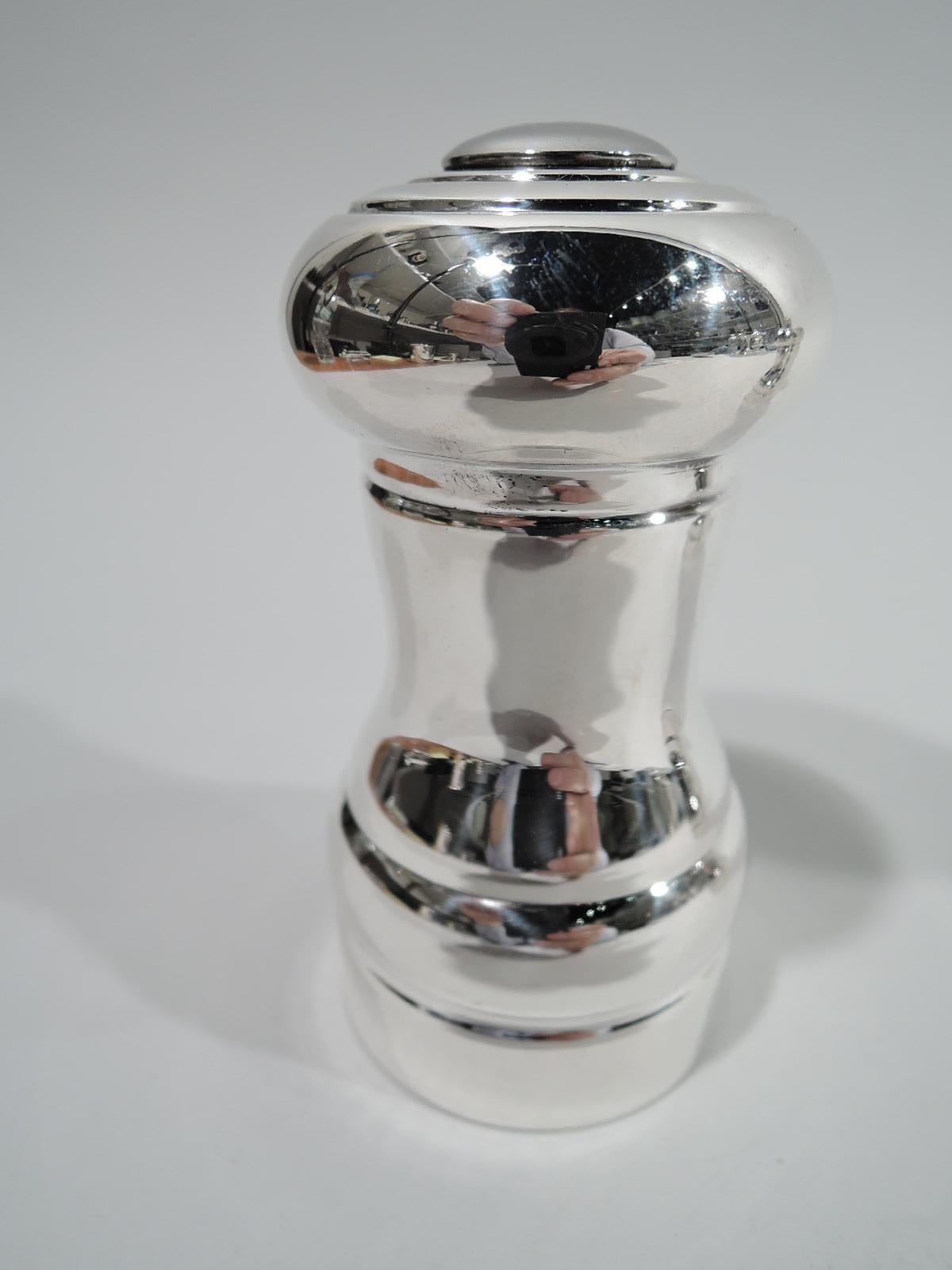 Modern sterling silver salt and pepper. Each: Waisted column with round and bellied top. Salt: Top has pierced center and concentric rings. Bottom has cork plug. Pepper: Rotating top with threaded finial. Marked “Towle Sterling” with nos. 901 (salt)