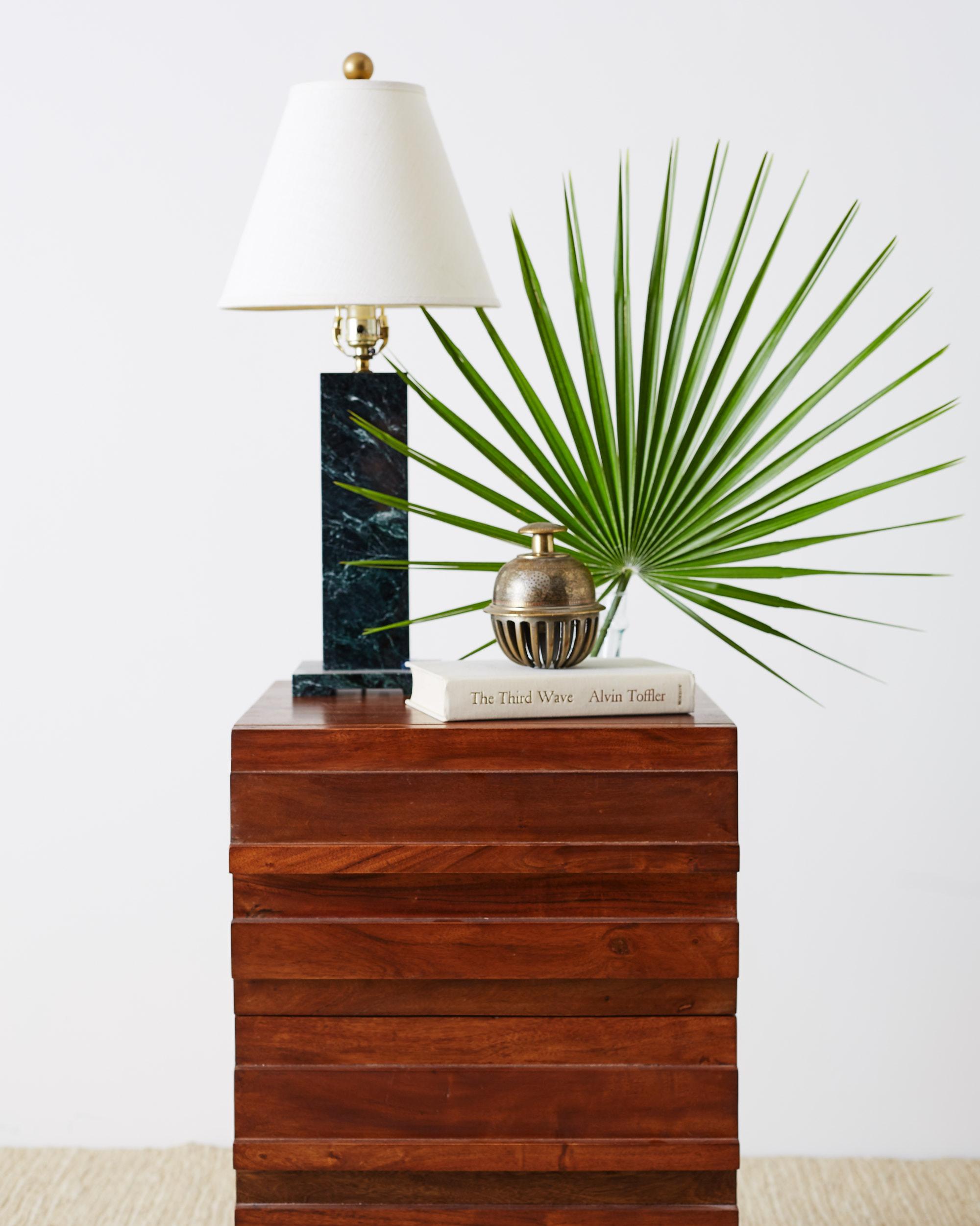 Pair of American modern style mahogany nightstands on hairpin legs. Richly grained planks of wood cover the case fronted by two large drawers. The nightstands or end tables have a style reminiscent of Paul McCobb, Planner Group or Paul Evans