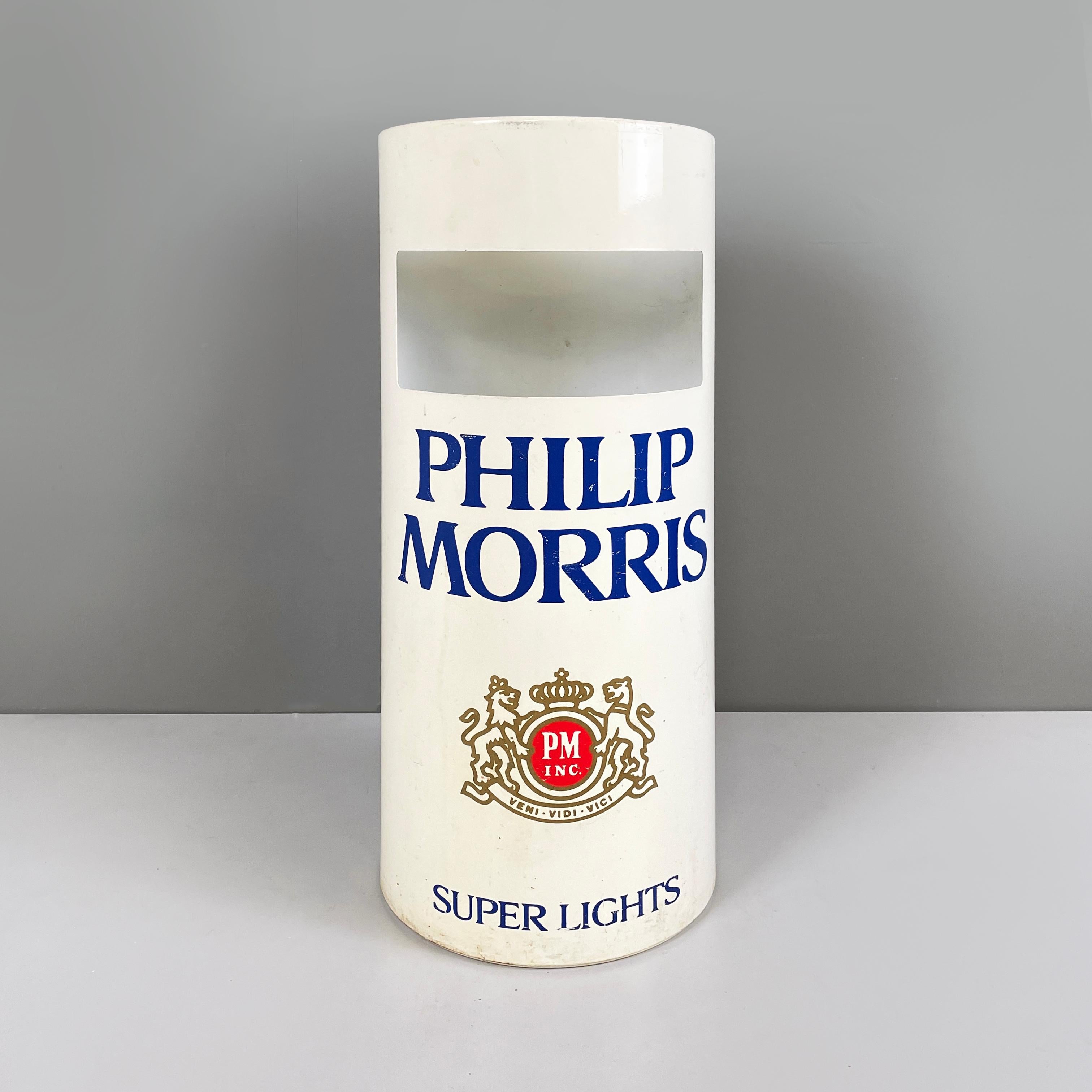 American modern Round base umbrella stand in white metal by Philip Morris cigarette, 1990s
Cylindrical umbrella stand in white metal with rounded upper profile. On the front it has a rectangular hole. On both sides there is the logo of the
