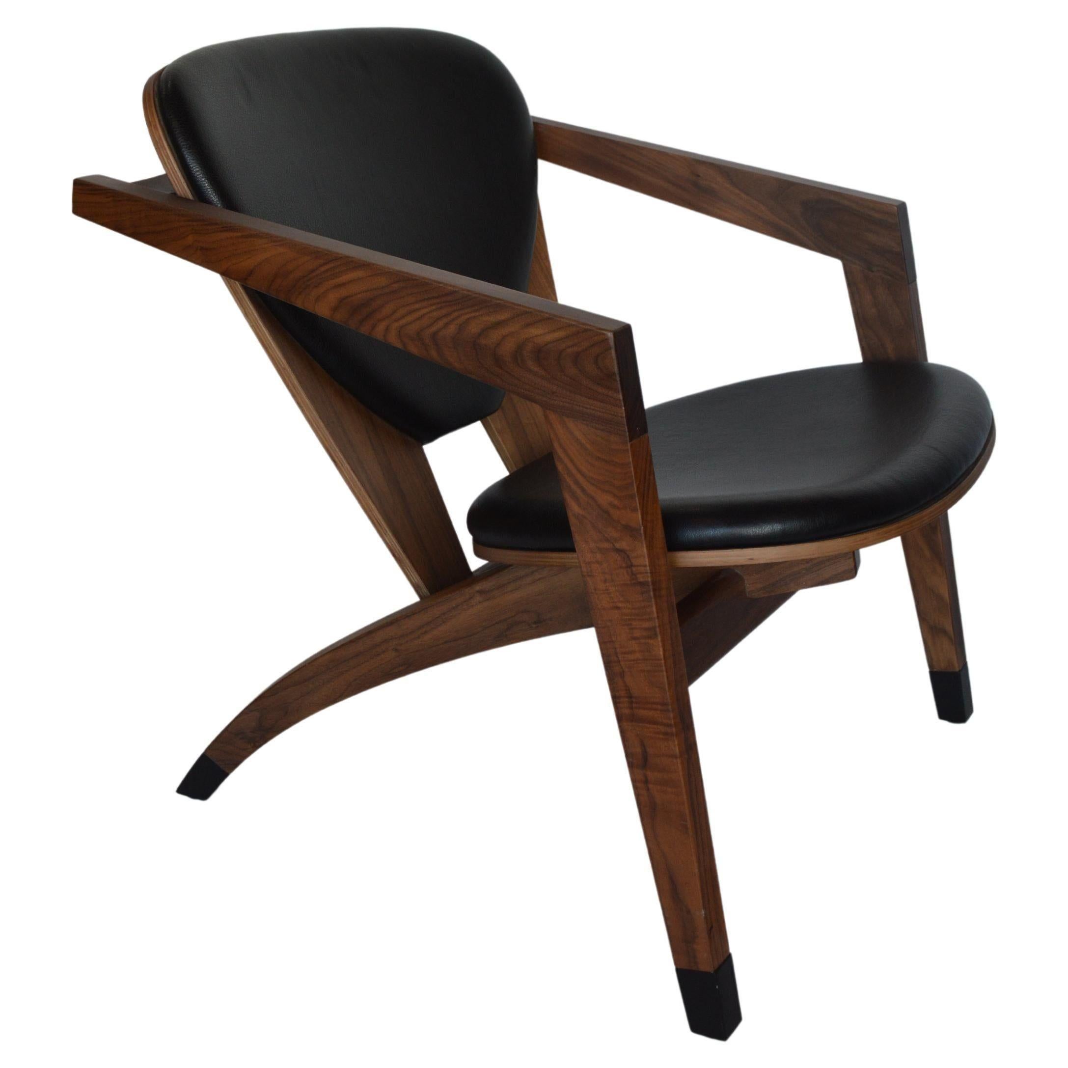 American modern walnut armchairs with leather upholstery. USA, 21st Century.