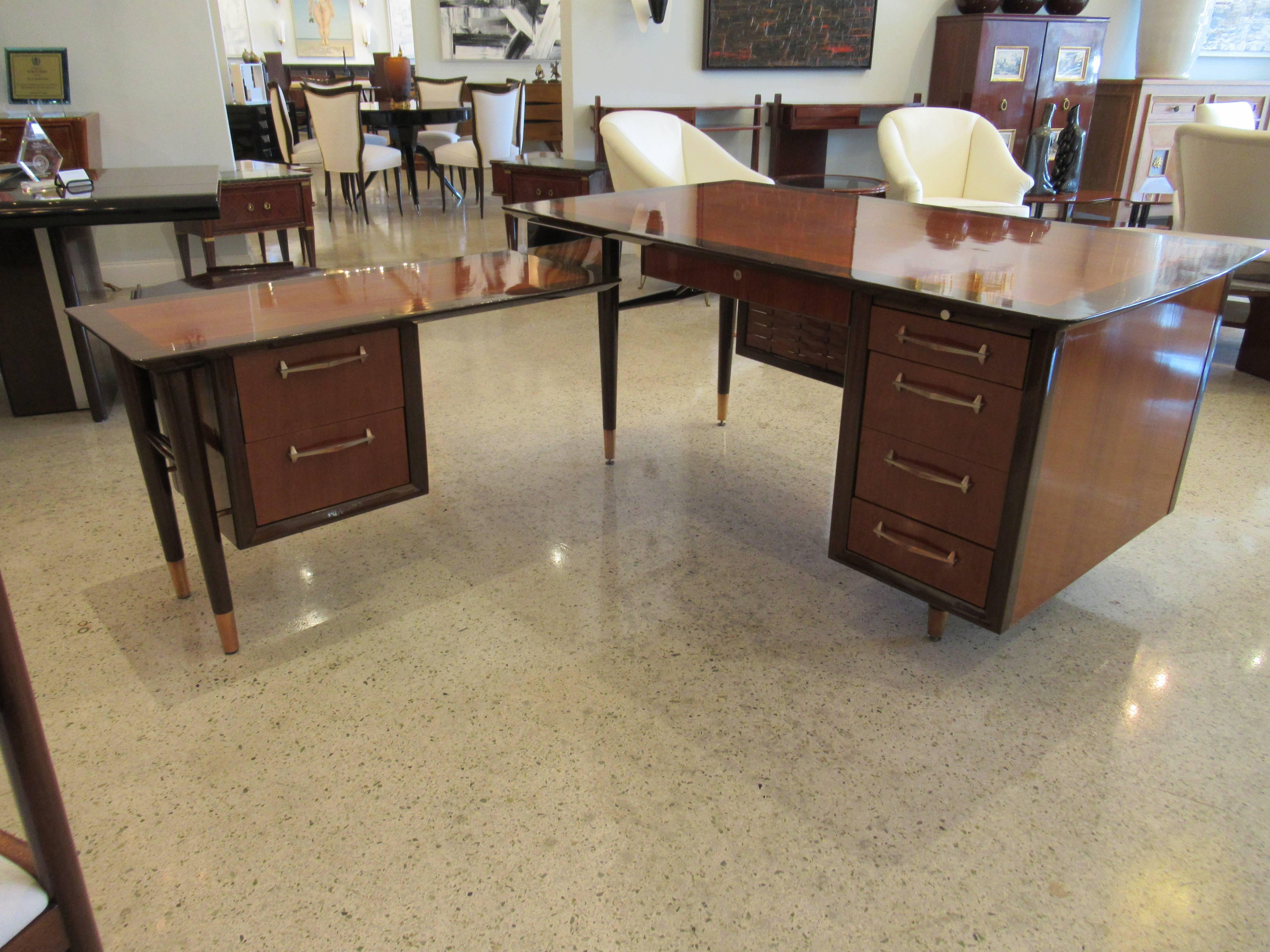 The rectangular top and return with dark walnut banding and central mahogany top, above a woven frontal area and round tapering legs with brass caps, the interior side with one pencil drawer and a bank of three drawers, one being a file cabinet