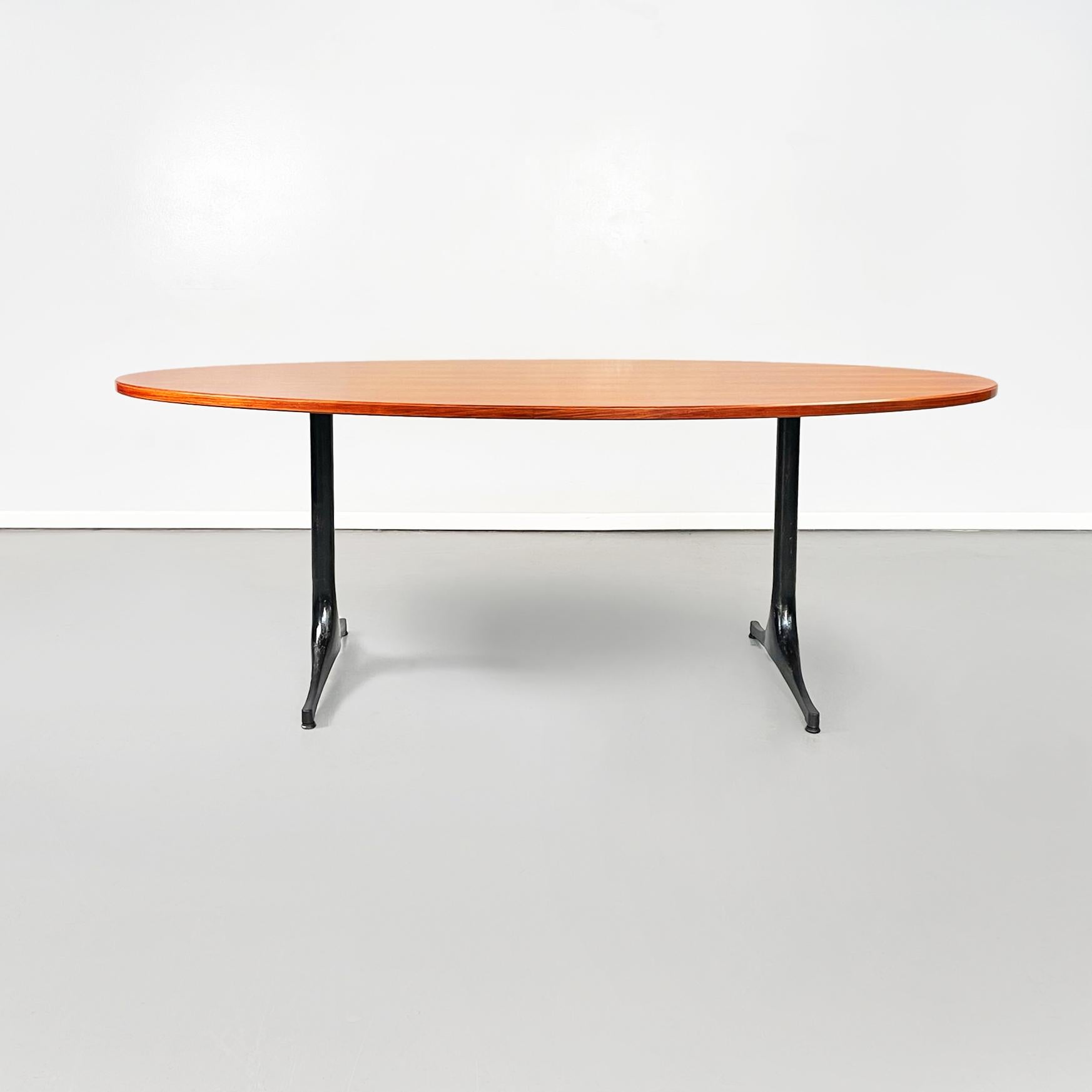 American Modern wood and black metal Dining table by George Nelson for Herman Miller, 1960s
elegant and fantastic dining table with thick oval wooden top. The structure is made up of two legs in black painted metal.
It was produced by Herman