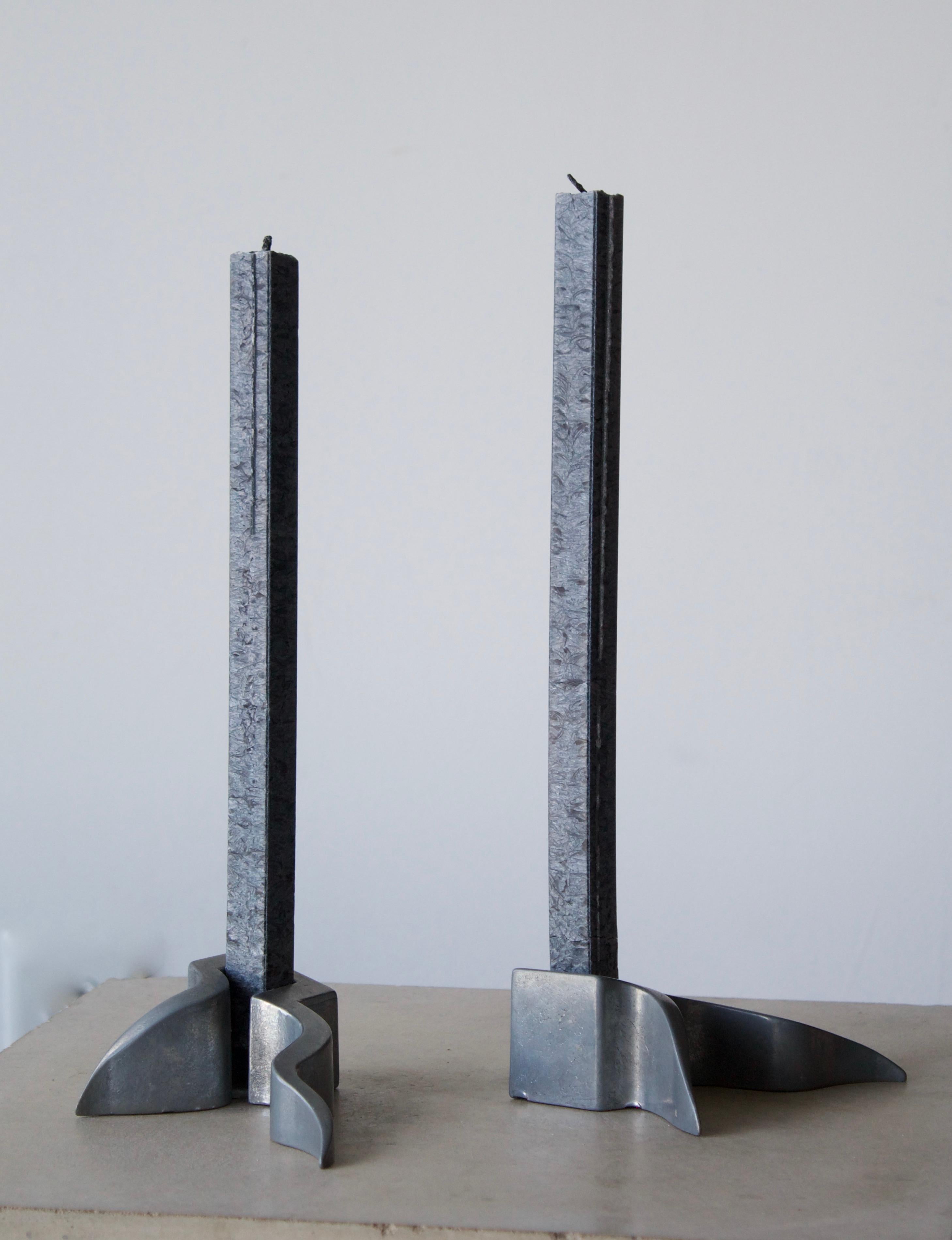 A pair of organic candlesticks / candleholders. In organically shaped metal. Holds square candles.

Other designers of the period include Isamu Noguchi, Vladimir Kagan, Gio Ponti, and Piet Hein.