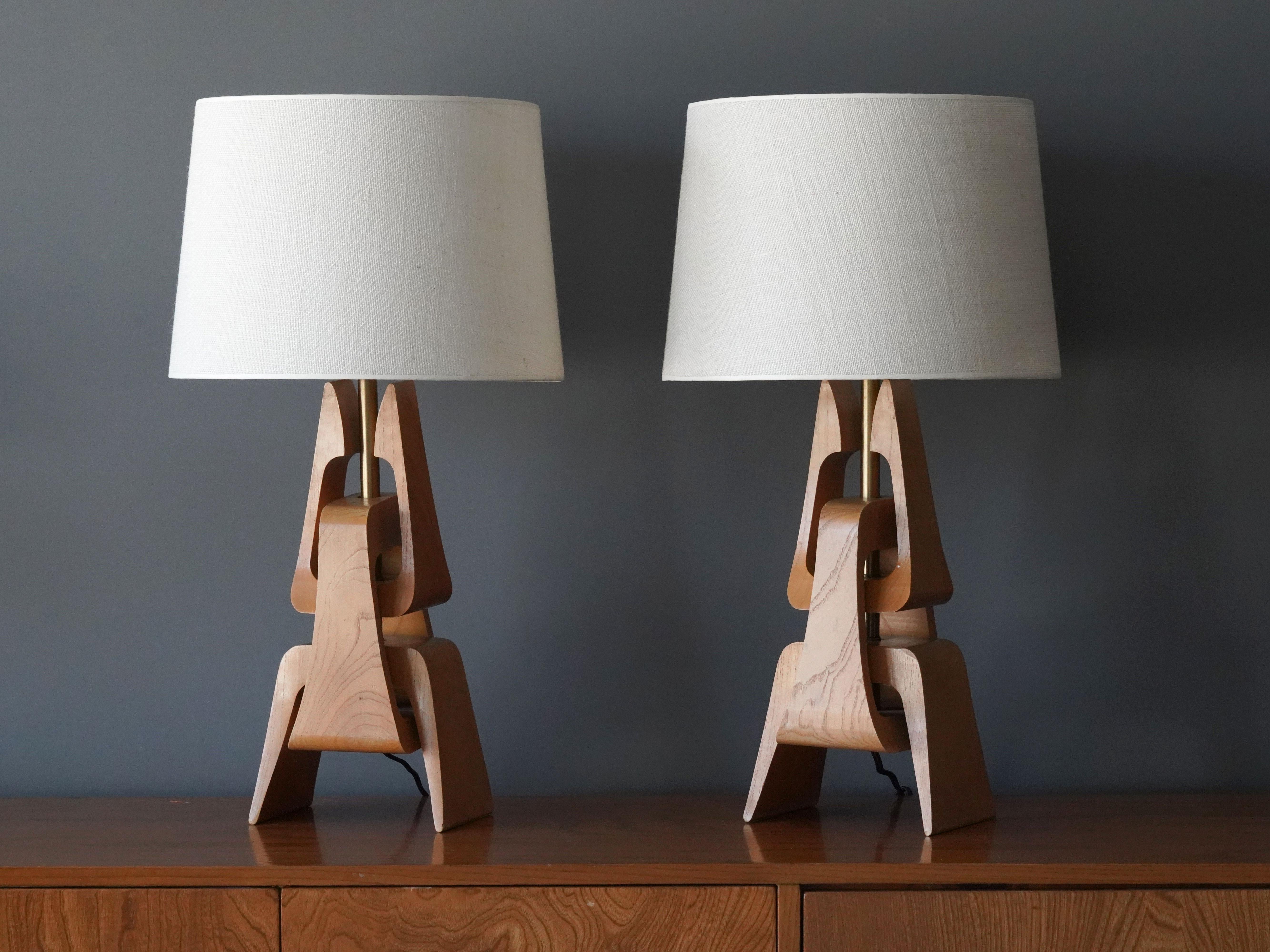 A pair of modernist table lamps. Designed by an unknown designer, America, 1950s. Intricate sculptured oak parts are joined on a brass rod.  Sold without lampshades.

Other designers of the period include Paul Laszlo, Paul Frankl, Isamu Noguchi,