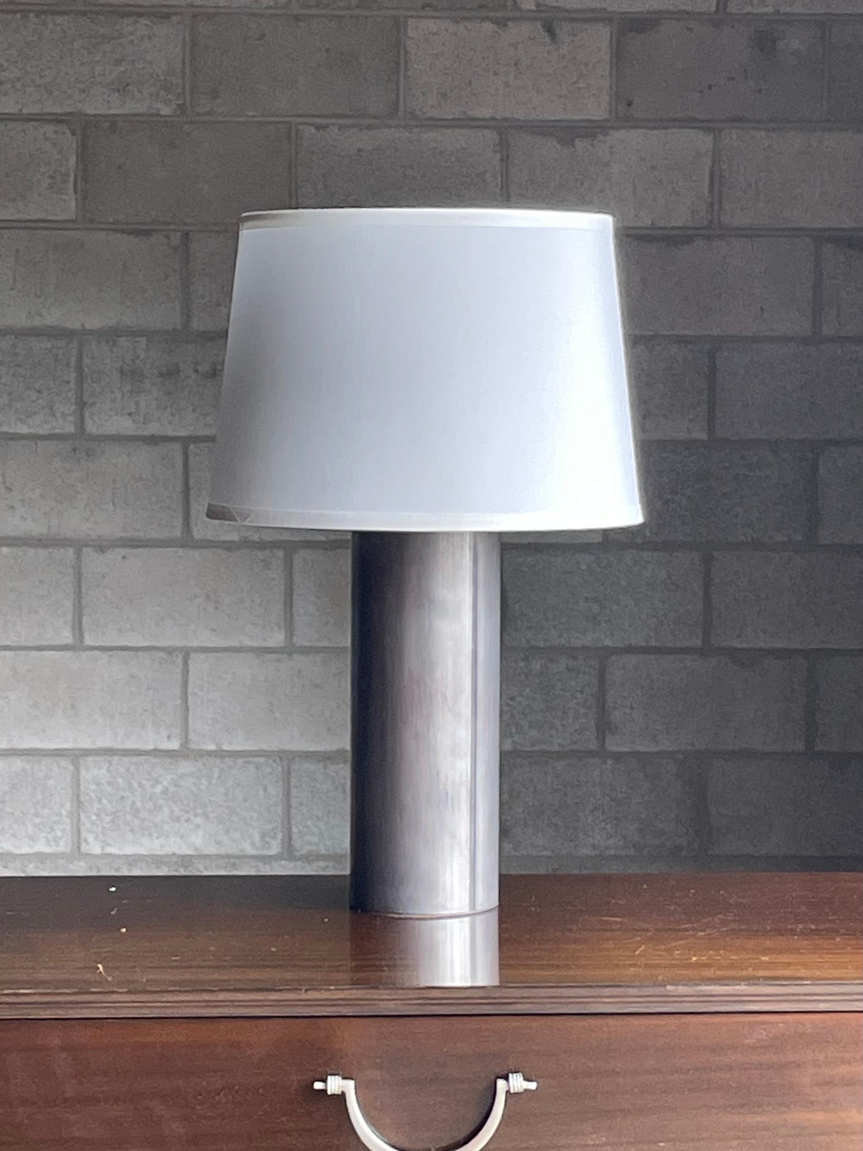 Unusual metal cylinder table lamp in the style of George Kovacs and Robert Sonneman. This appears to be a stainless steel body. Has a wonderful industrial, minimalist, modernist vibe to it which would work in a variety of interiors. 

Measures: