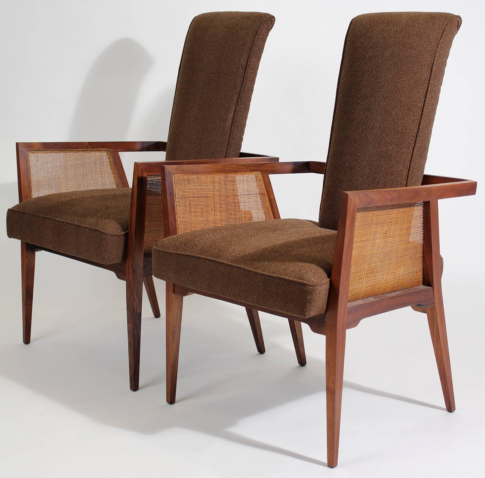 Beautiful set of American modernist walnut and cane tall back sitting or desk accent arm chairs. These would look great as accent to any room or desk. Made of solid American walnut wood with cane sides. The chairs have been re-upholstered and