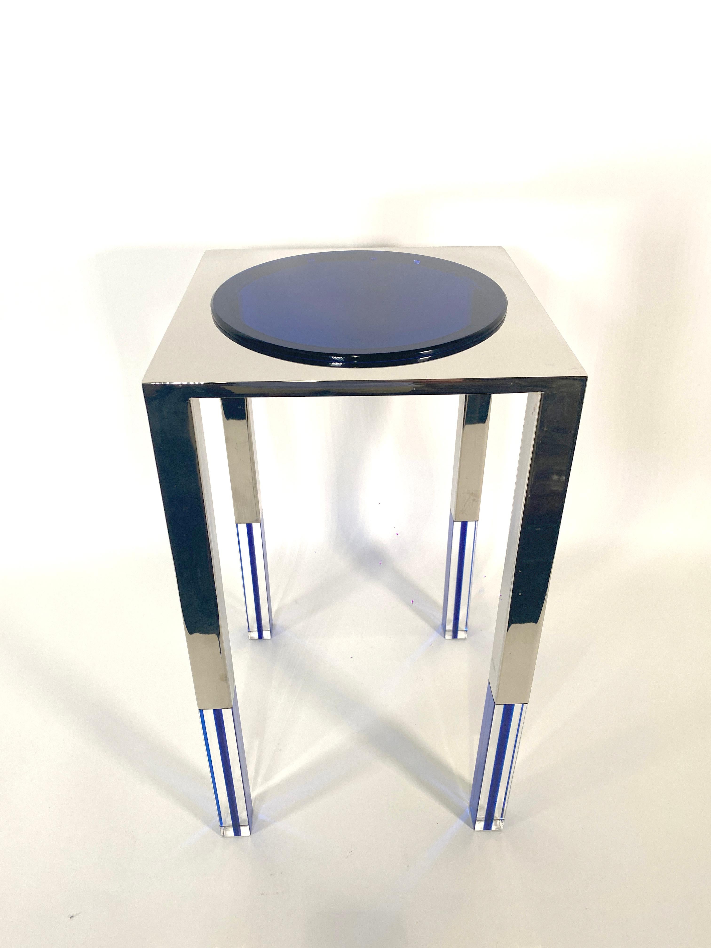 the blue lucite disc top surrounded by a polished nickel platform on square legs alternating in clear lucite, blue lucite and polished nickel. Production will be limited to 12 pieces of this total.We are the exclusive dealers for this table for