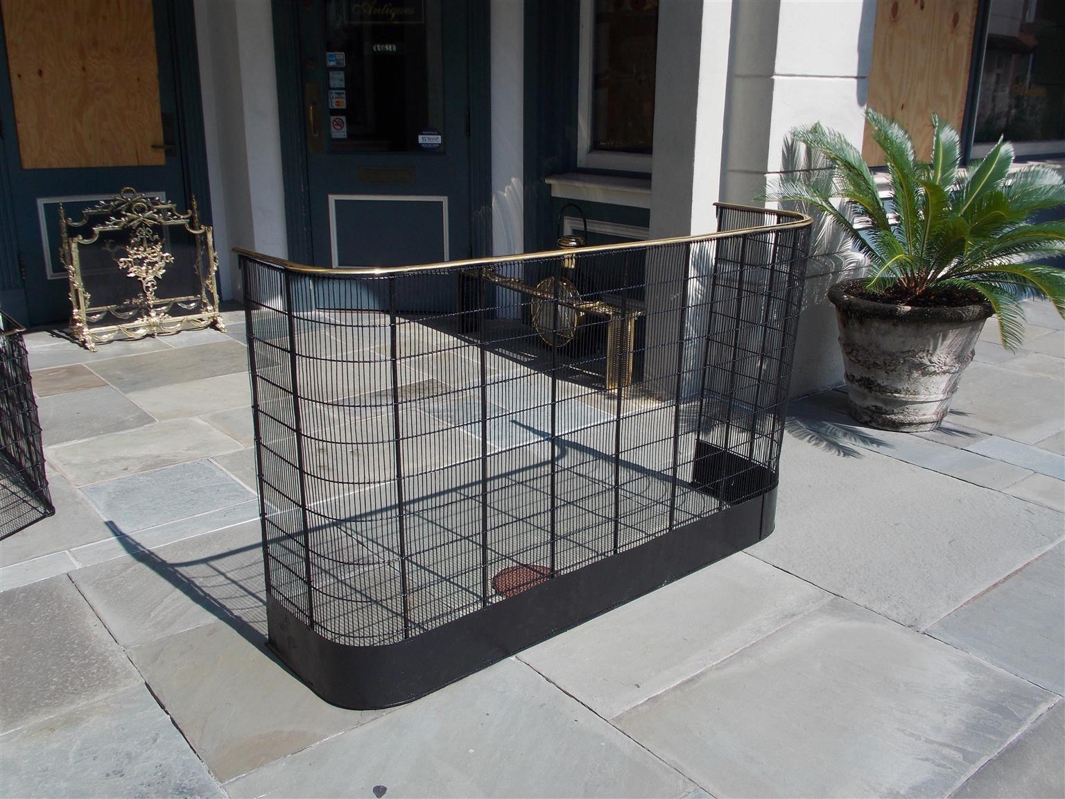 American monumental brass rail top and wire work fireplace screen with the original surround attaching side hooks, Early 19th century, 