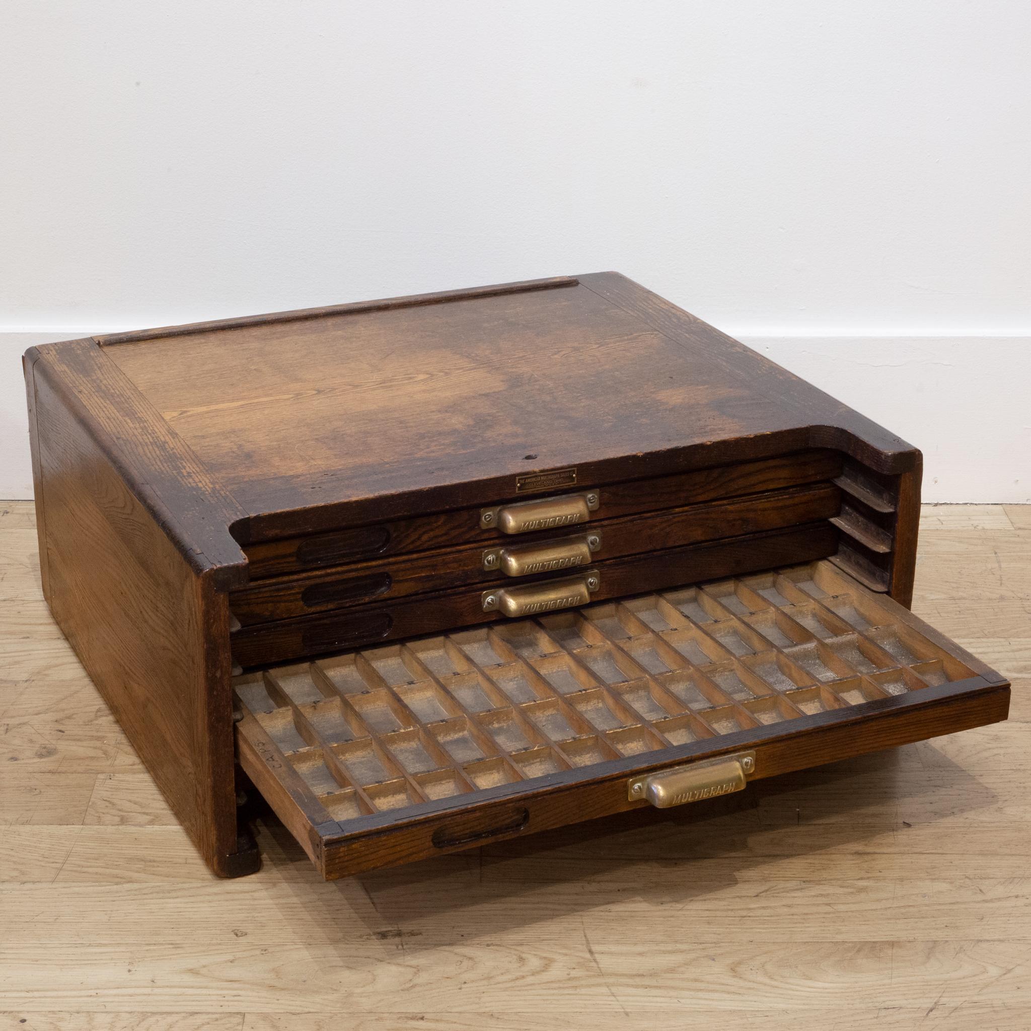 About

An early 20th century typesetter's table top cabinet with brass handles, original label and segmented drawers used to house steel typeset letters. The bottom of each space in the drawers is curved for better gripping. The piece is