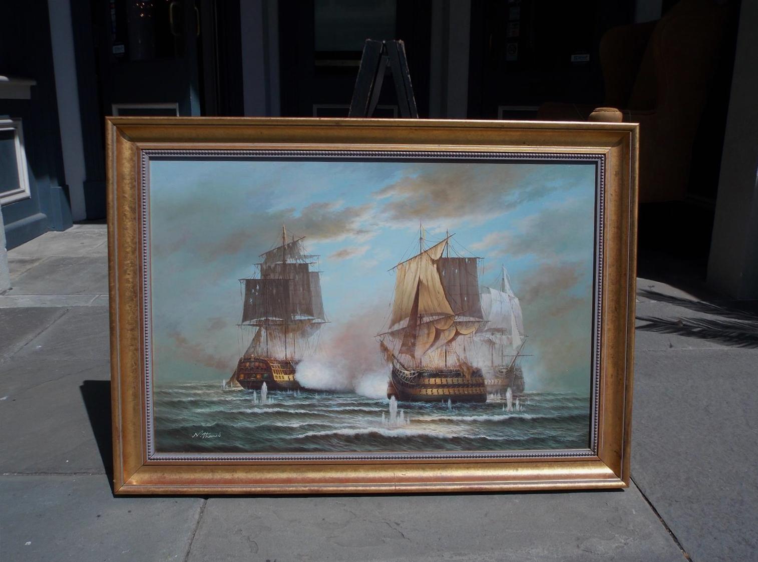 American Nautical oil on canvas with three battling ships at sea in the original gilt frame, 20th century. Signed by Artist N. Thomas.