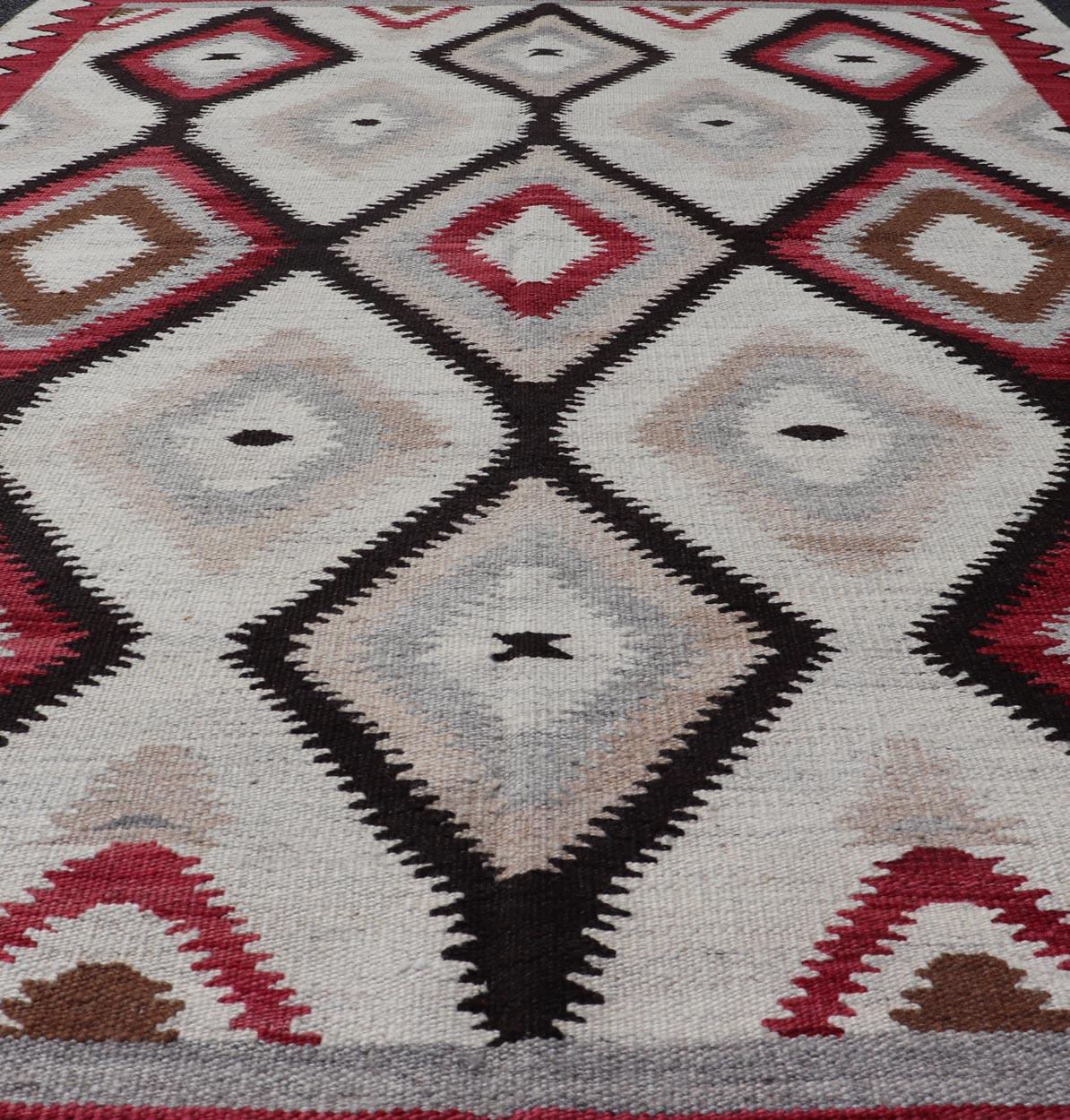 American Navajo Design Rug with Latticework Tribal Design in Red, Black and Gray. Keivan Woven Arts / rug RSC-85543-AR-166, country of origin / type: North America / Navajo, circa early 21st century. 
Measures: 5'2 x 7'9 
This intriguing