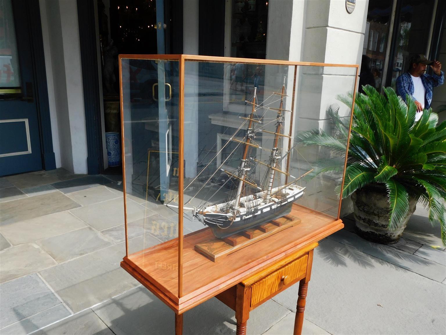 American Naval two masted clipper ship brig model mounted on stand under a glass case. The US Perry was a brig commissioned by the United States Navy October 1843 prior to the American Civil War. She was tasked by the Navy for various missions,
