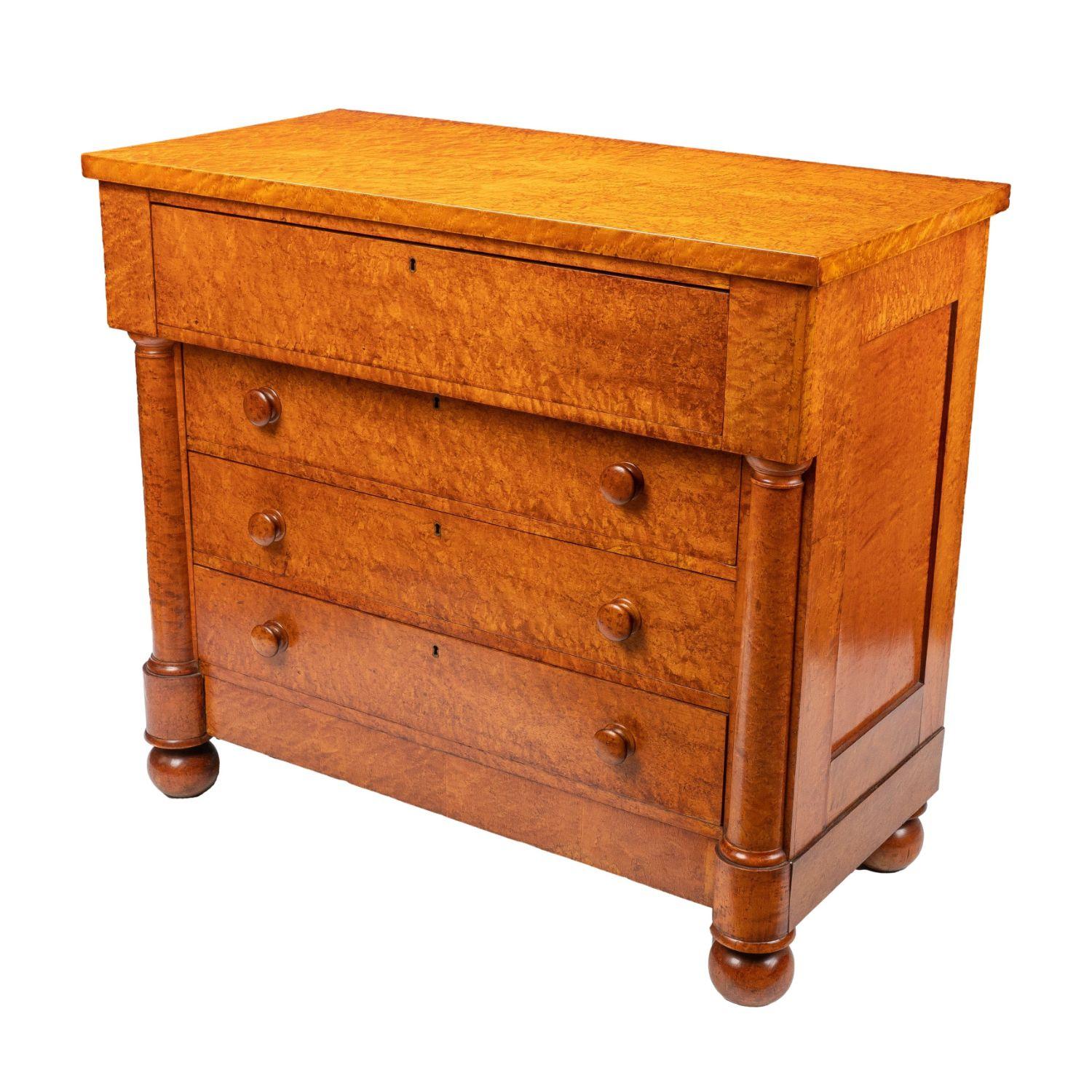 American Neoclassic four drawer chest in the French Restoration taste. The case employs both solid and veneered bird’s-eye maple in choice selection of overall pattern. The top is matched bird’s maple over a full width blind top drawer projecting