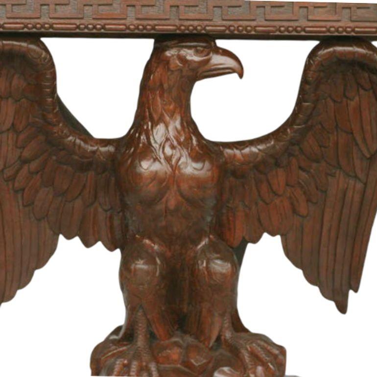 American neoclassical hand-carved console table. The rectangular oak top is supported by an eagle with spread wings holding, the tapering plinth with carved relief of Greek key and hand-carved detailing along the base.
Possibly George III
Two