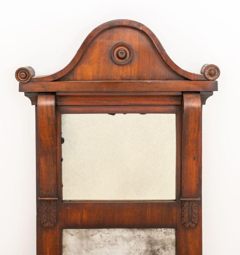 American Neoclassical mahogany tall mirror, one metal candle stick to one side (missing one), circa nineteenth century.