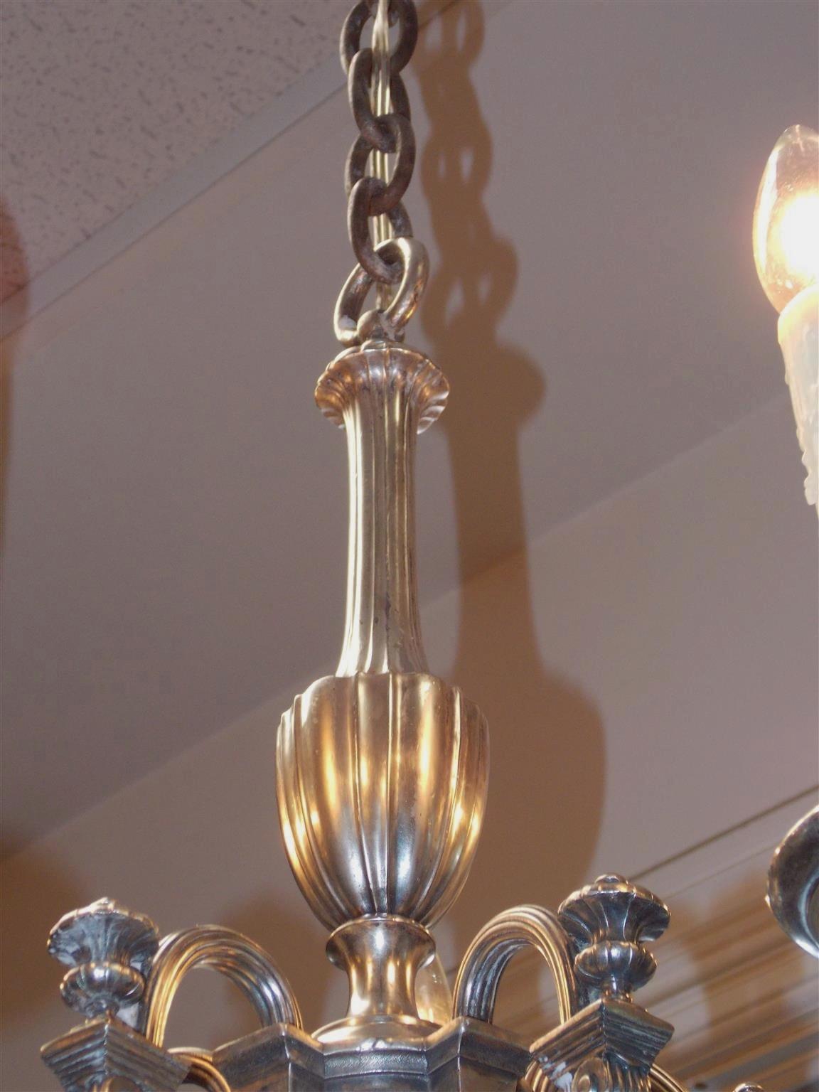 American nickel silver over steel five light chandelier with a centered ring and fluted urn , scrolled ribbed arms with urn finials over architectural corbels, and resting on a ribbed melon base with a lower fluted finial. Late 19th century.