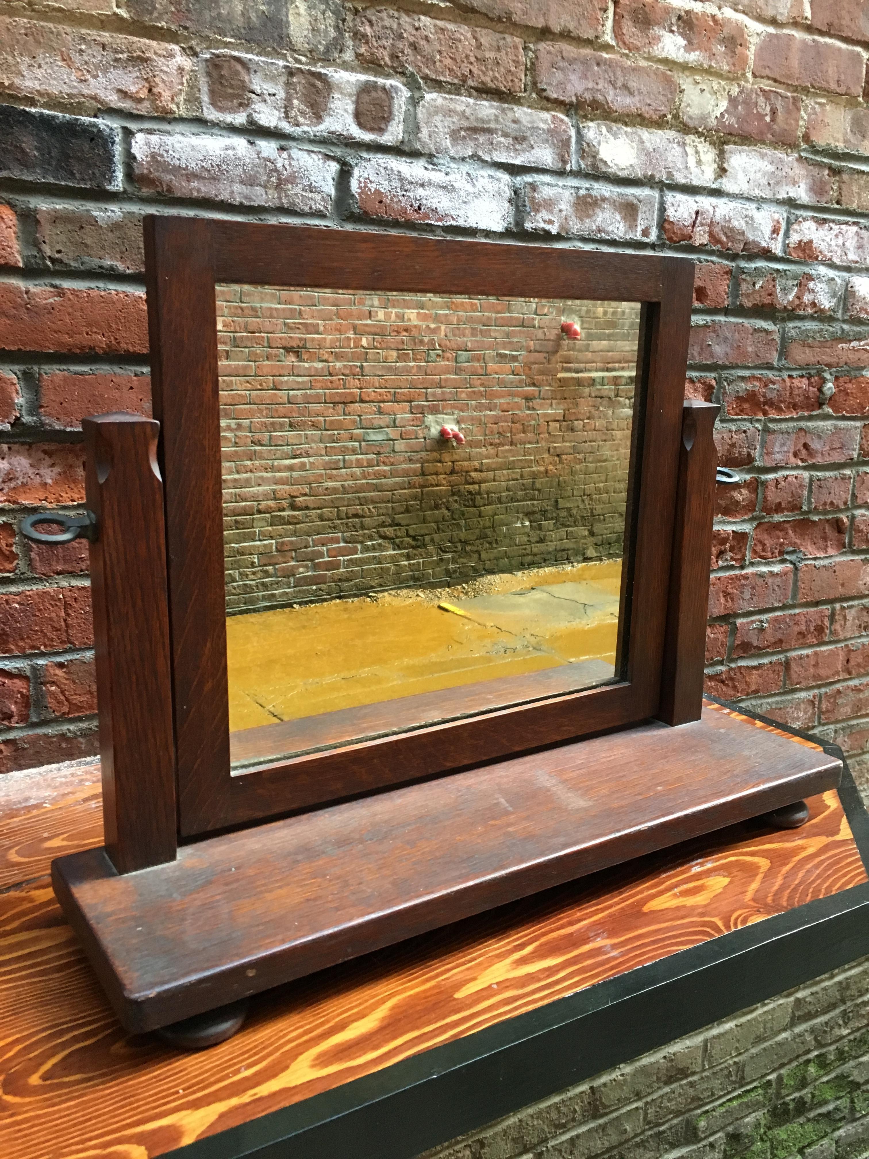 Constructed from solid American white quarter sawn oak. Adjustable mirror, carved posts resting on four bun feet. Old dark finish, circa early 20th century. Great for an overmantel, tabletop or dresser.

Measures: 6.75