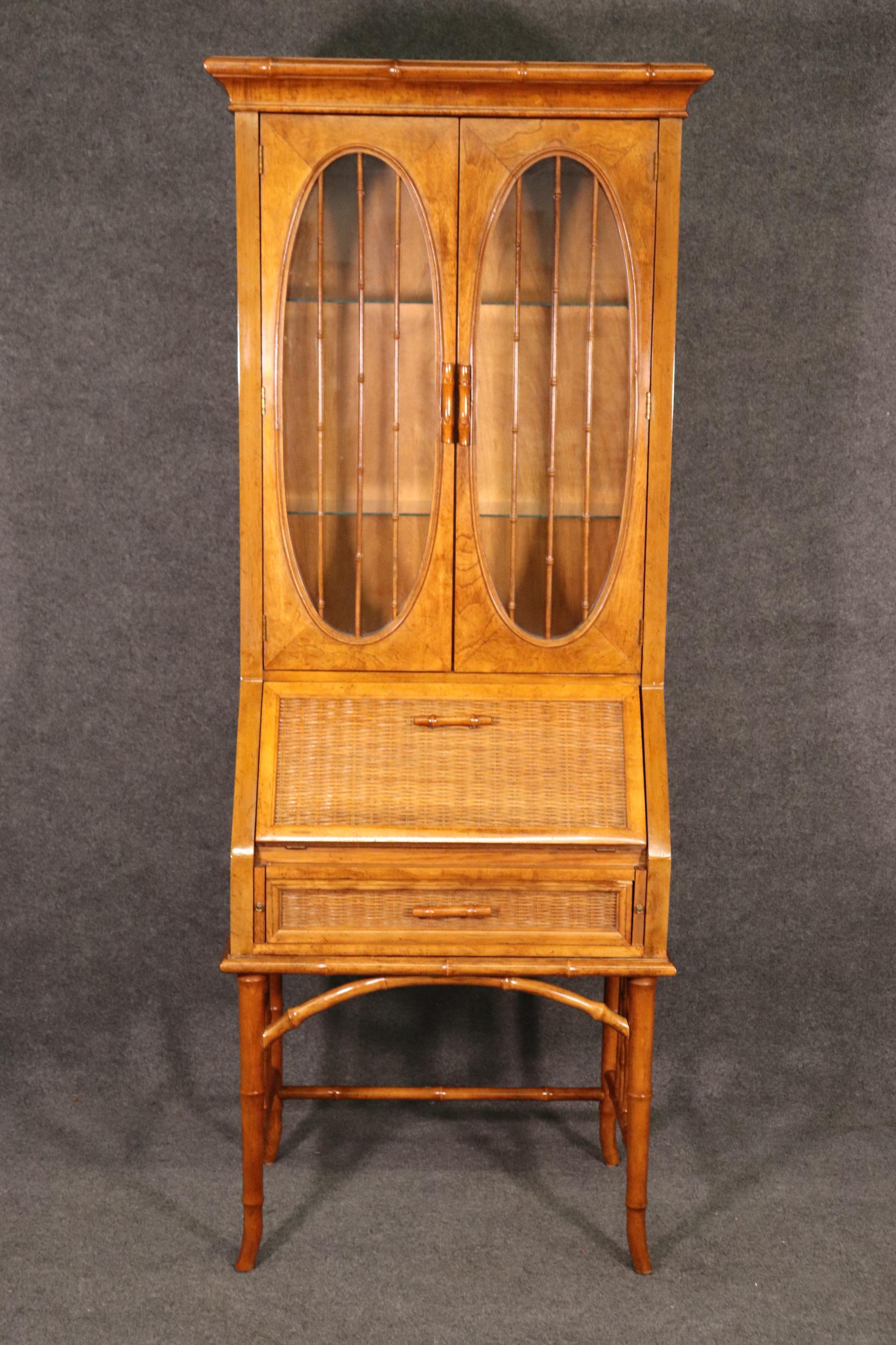 This Hollywood Regency Style Faux Bamboo 2 Piece Secretary desk made by American of Martinsville is a super handsome piece that brings a nice touch of sophistication into your home or office. American of Martinsville was established in 1906 and