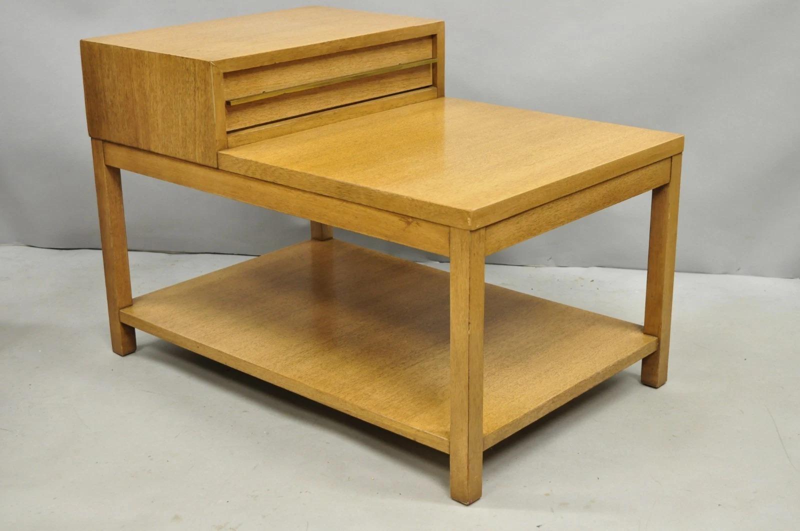 Vintage American of Martinsville Blonde Mahogany Mid Century Modern Step Up 2 Tier End Table with One Drawer and Brass Pull. Circa Mid 20th Century. Dimensions : 21