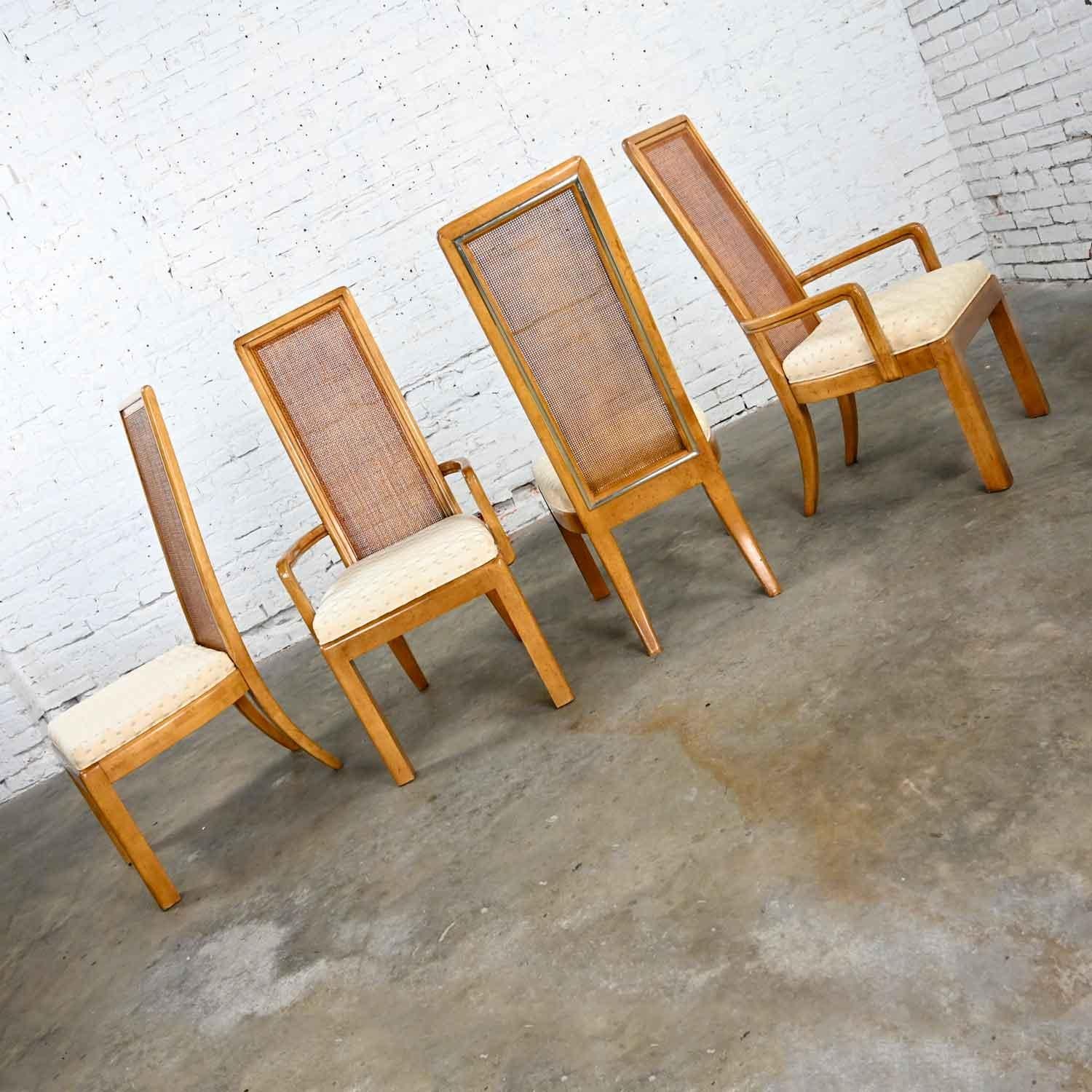 Stunning set of 4 modern campaign style dining chairs 2 Arm and 2 side chairs comprised of beautiful light hardwood, radio weave cane seat backs, and fabric covered seats. Beautiful condition, keeping in mind that these are vintage and not new so