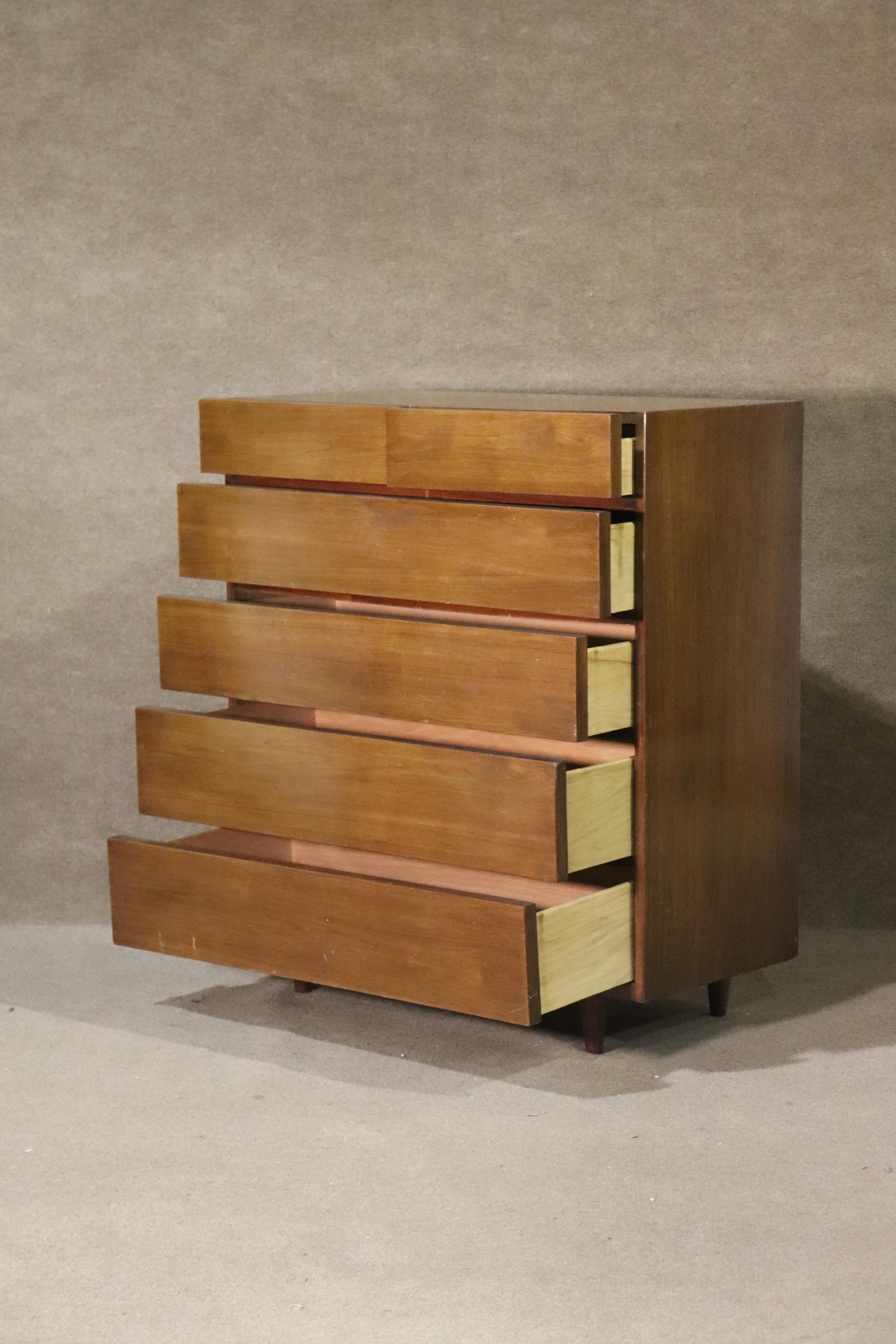 Tall chest of drawers made by American of Martinsville. Mid-century modern style with a simple squared esthetic in warm walnut grain.
Please confirm location NY or NJ