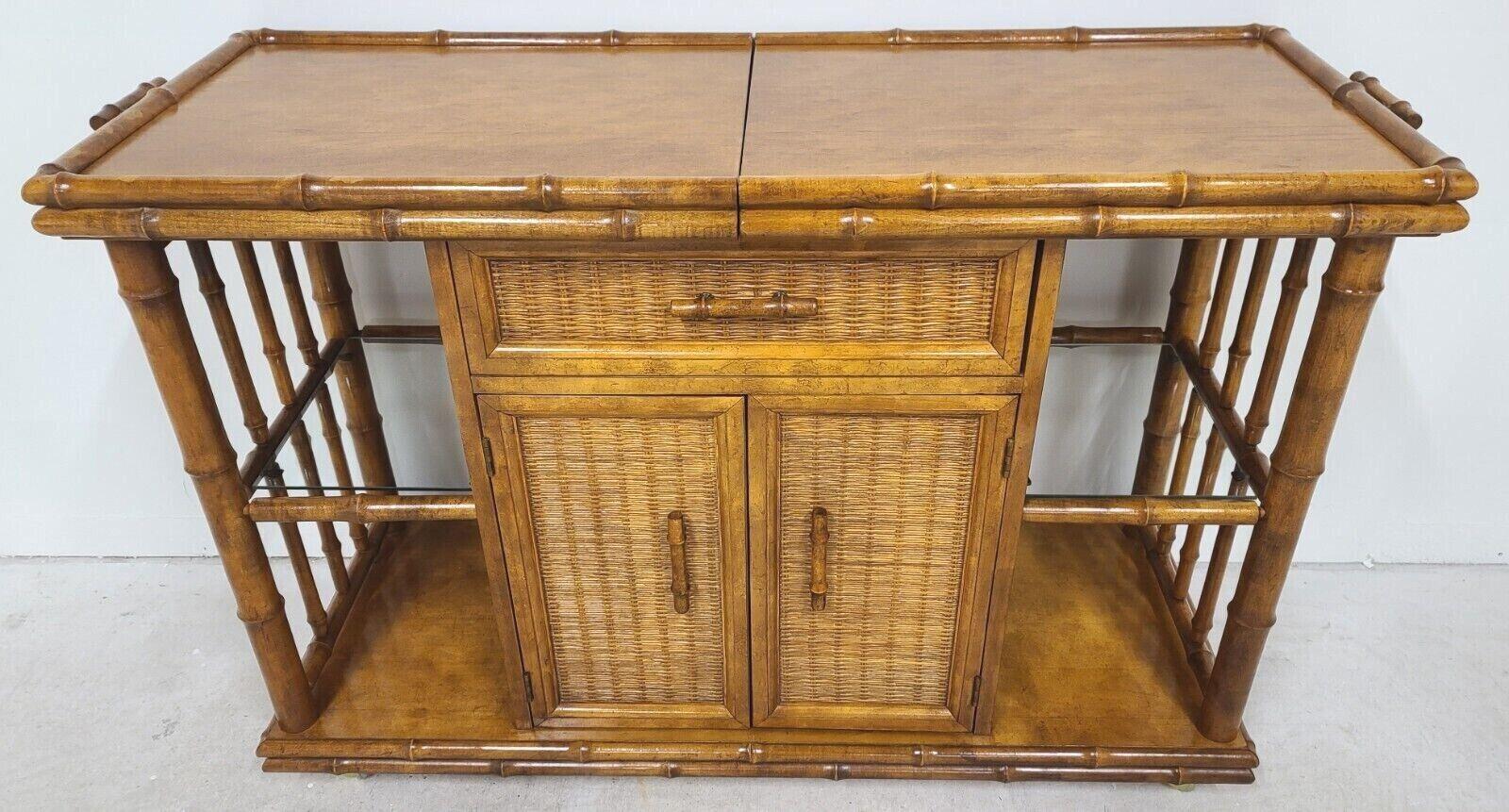 For full item description be sure to click on CONTINUE READING at the bottom of this listing.

Offering one of our recent palm beach estate fine furniture acquisitions of a
American of Martinsville faux bamboo rattan rolling slide top sideboard