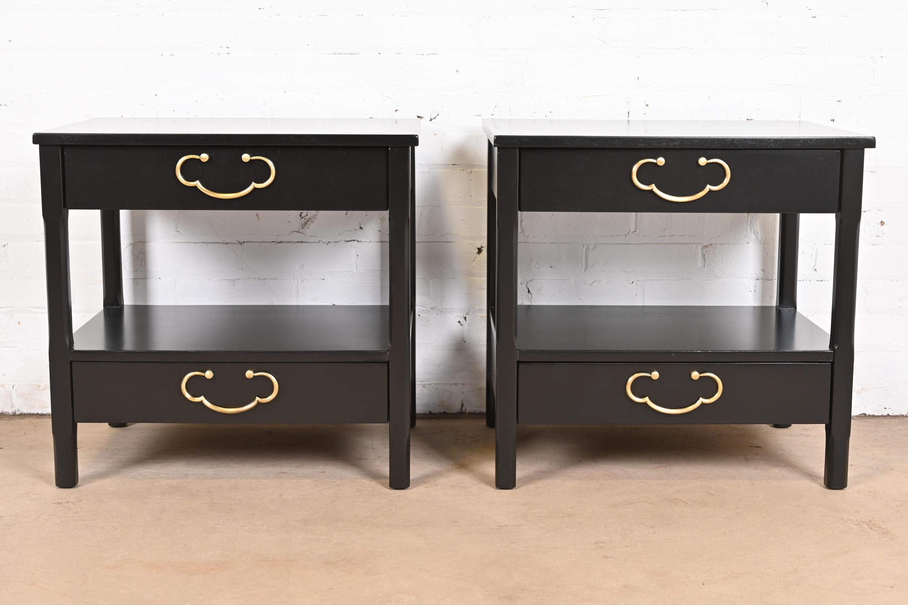 A gorgeous pair of Mid-Century Modern two-drawer nightstands

By American of Martinsville

USA, 1960s

Black lacquered walnut, with original brass hardware.

Measures: 23