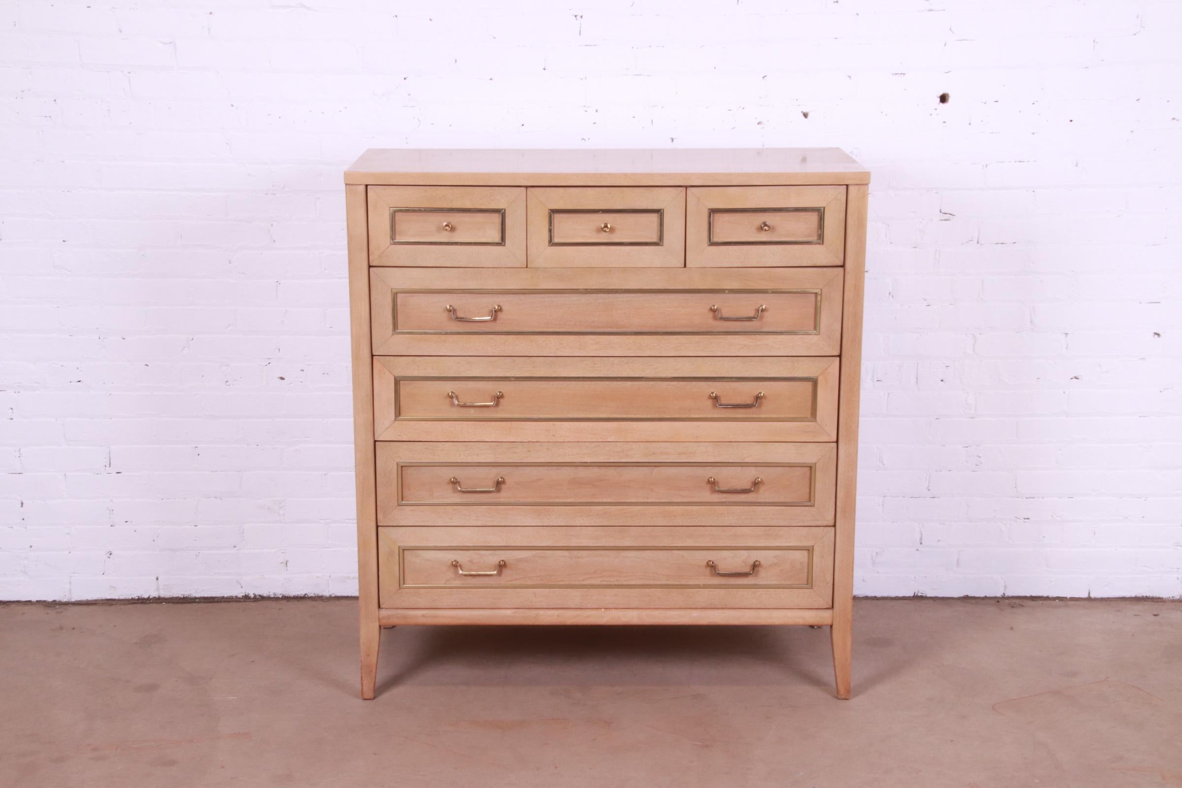 A gorgeous Mid-Century Modern Hollywood Regency seven-drawer highboy dresser

By American of Martinsville

USA, Circa 1960s

Bleached mahogany, with brass trim and hardware.

Measures: 42.25