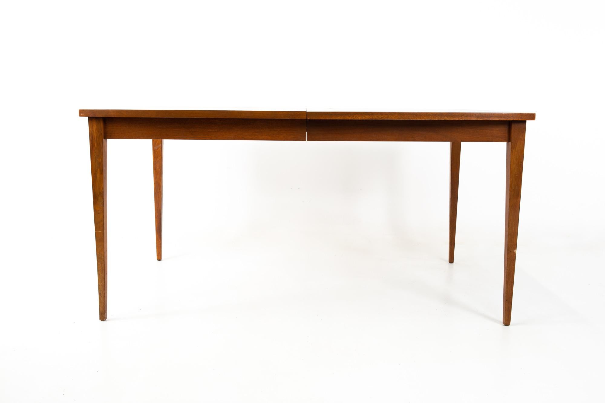 American of Martinsville Mid Century walnut 10 person dining table
Without leaves this table measures: 60 wide x 40 deep x 30 inches high and has a chair clearance of 25.5 inches; with the two 18 inch leaves the table measures 96 inches wide

This