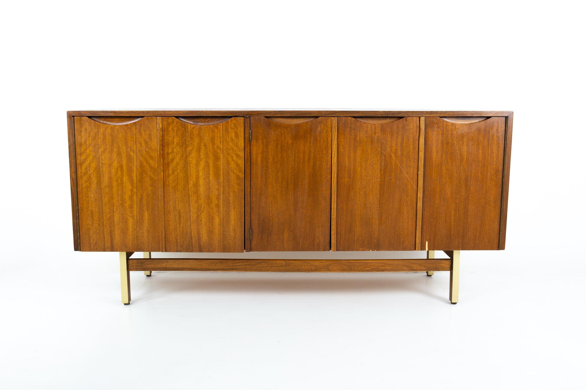 American of Martinsville Mid Century walnut and brass accordion door credenza
Credenza measures: 64 wide x 18.5 deep x 30 inches high

This price includes getting this piece in what we call restored vintage condition. That means the piece is