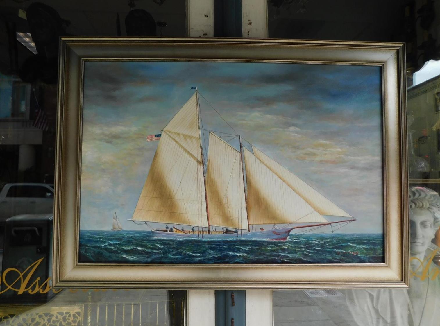 American nautical oil on canvas of two masted schooner yacht under full sail with American flag, crew on deck, second vessel in distance, and mounted in a silver gilt frame, Early 20th century. Signed D. Tayler.
 