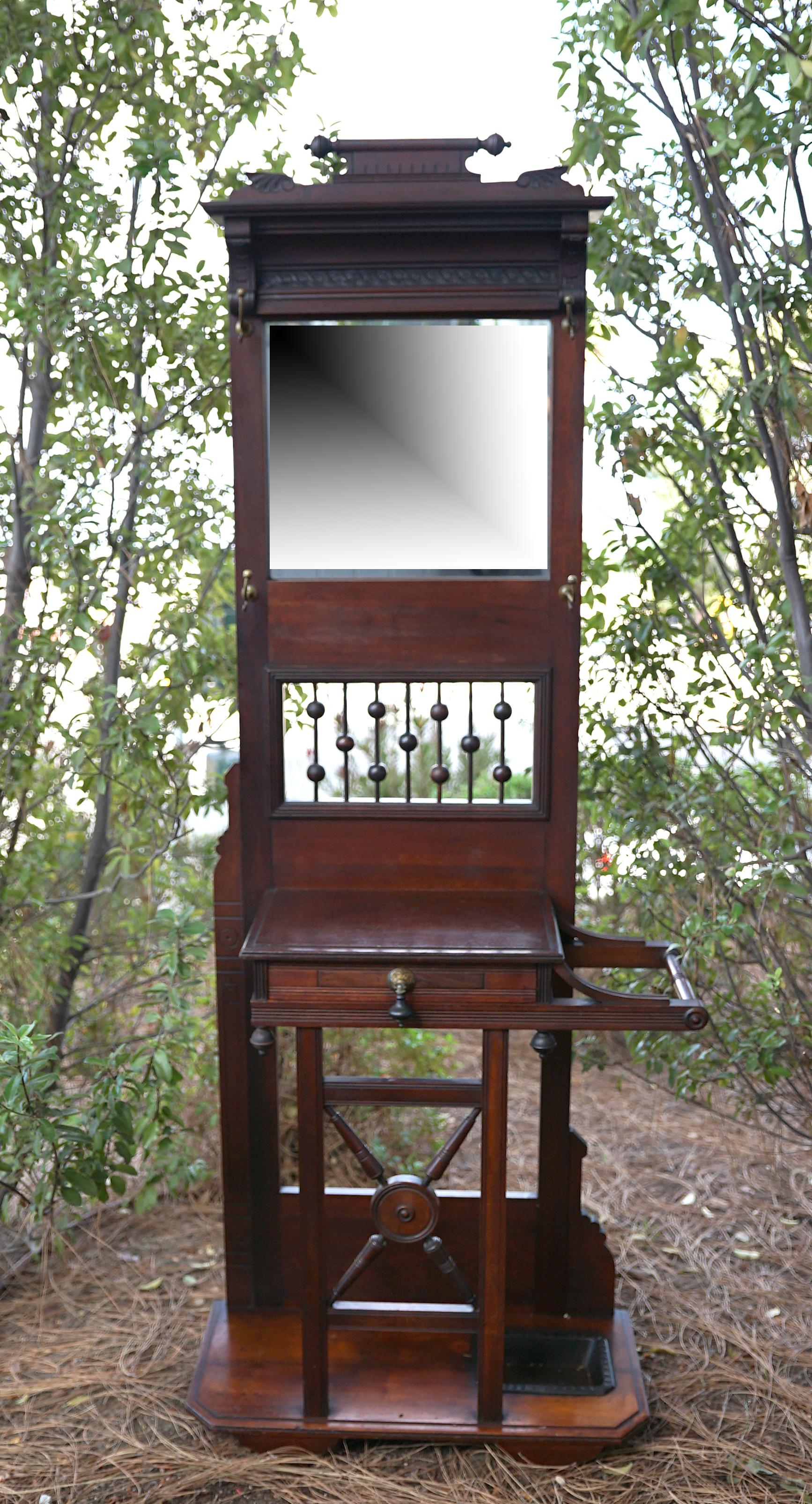 The patina, the form, the function and the overall presentation of this antique 
Aesthetic Movement mahogany hall tree make it worth a second and third look.
It has all the elegance of the stands that were popular in the US and UK at the turn of the