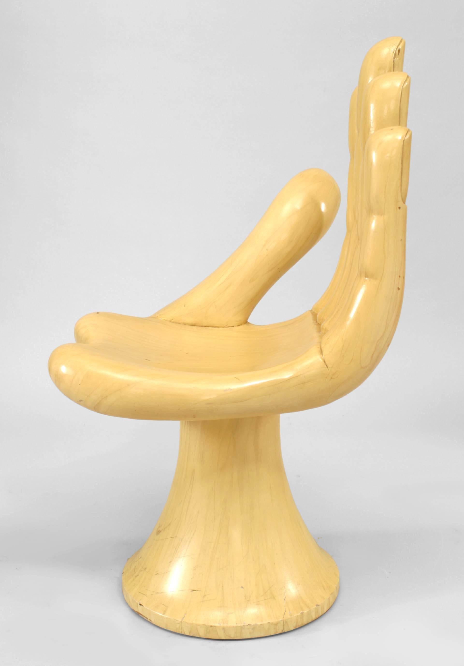 Two American/Mexican post-war design beige stained maple carved chair in the form of a cupped hand mounted on a round base (Attributed: Pedro Friedeberg) (priced each).
    