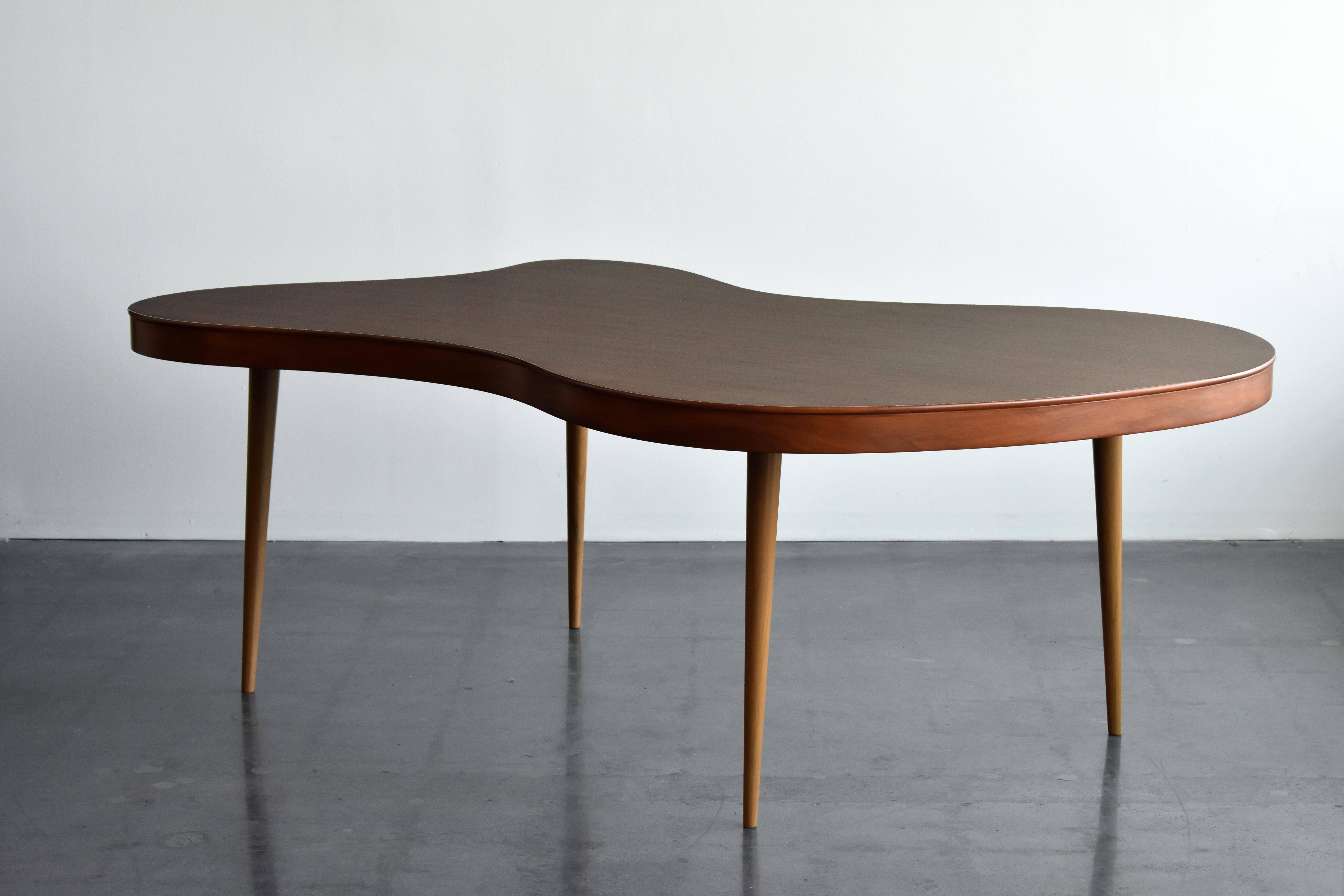 An organic/free-form dining table, an anonymous American designer, circa 1950s. Produced in oak. 

Bears a form similar to works by Paul Frankl, T.H. Robsjohn-Gibbings, Paul Laszlo, Gilbert Rohde, and Jean Royère. 

Also useable as games table or