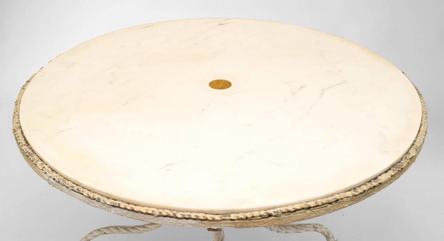 American (late 19th/20th Century) outdoor white-painted iron circular center table with white marble top on rope-twist stand.
