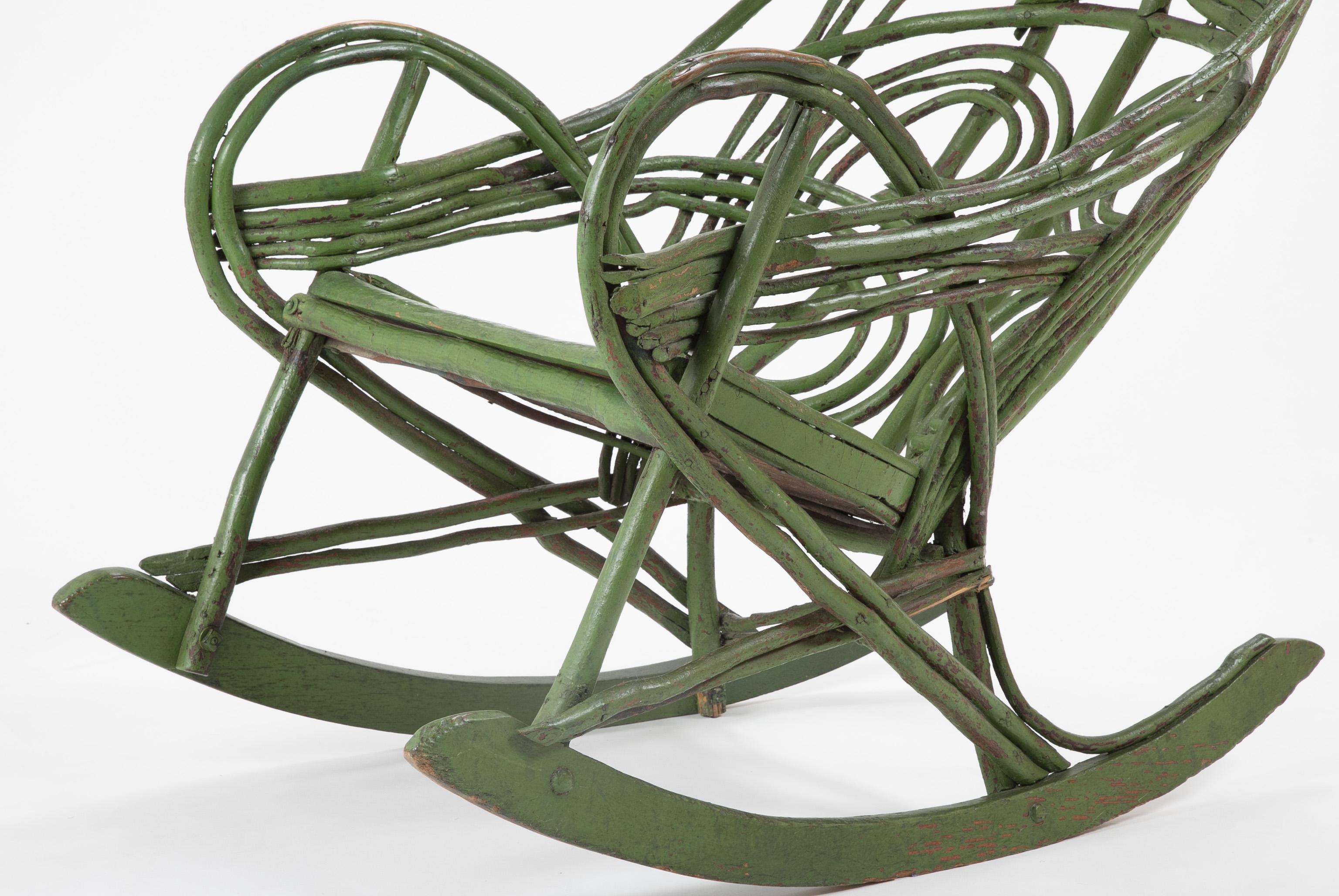 A painted green twig chair assumed to be from the Adirondacks, circa early 20th century.