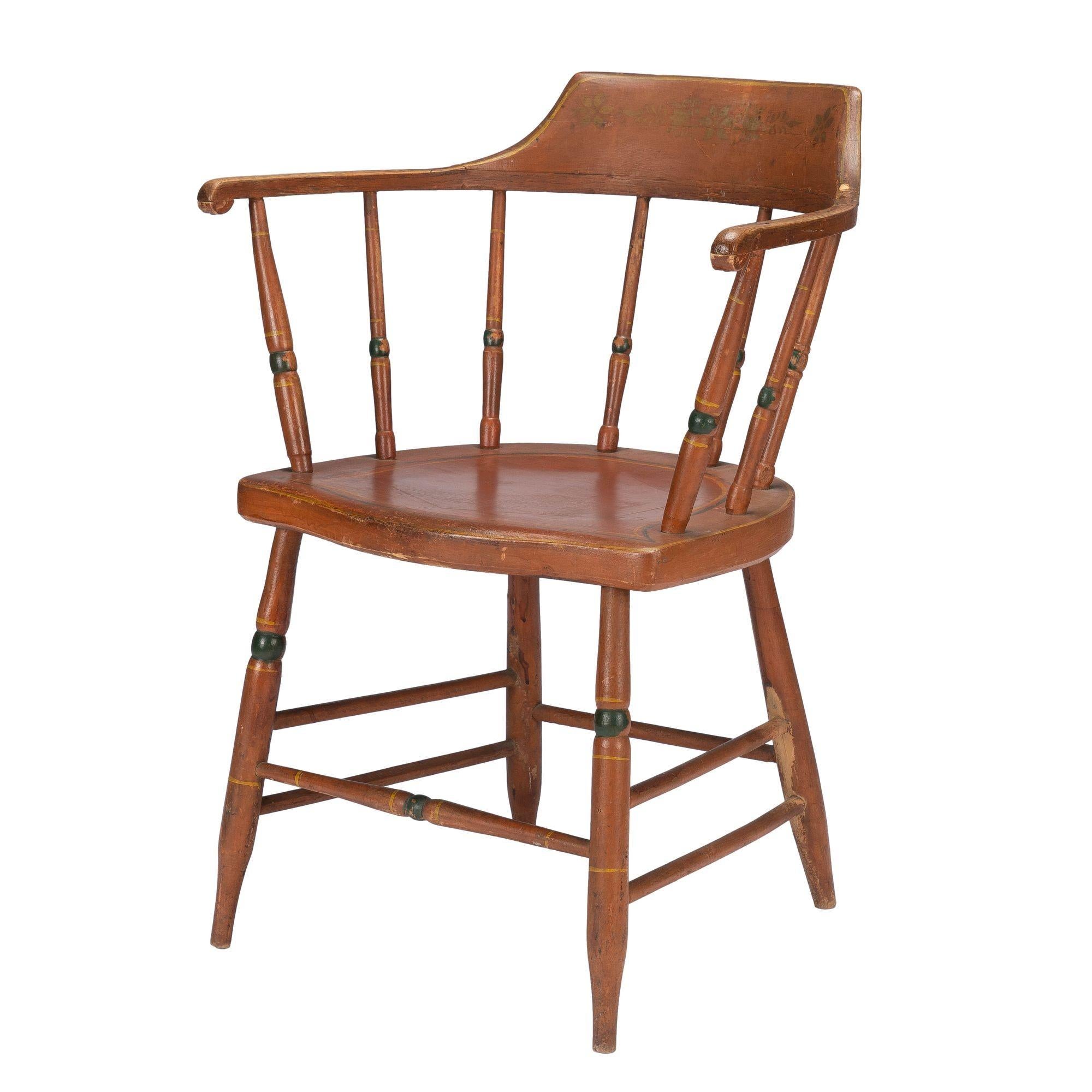 American Sheraton Windsor fancy chair in original oxide red painted finish with accent bands of green. There is a hexagonal inset design on top of the seat and a circular inset underneath. Comfortably scaled with a lovely patina.
American, circa