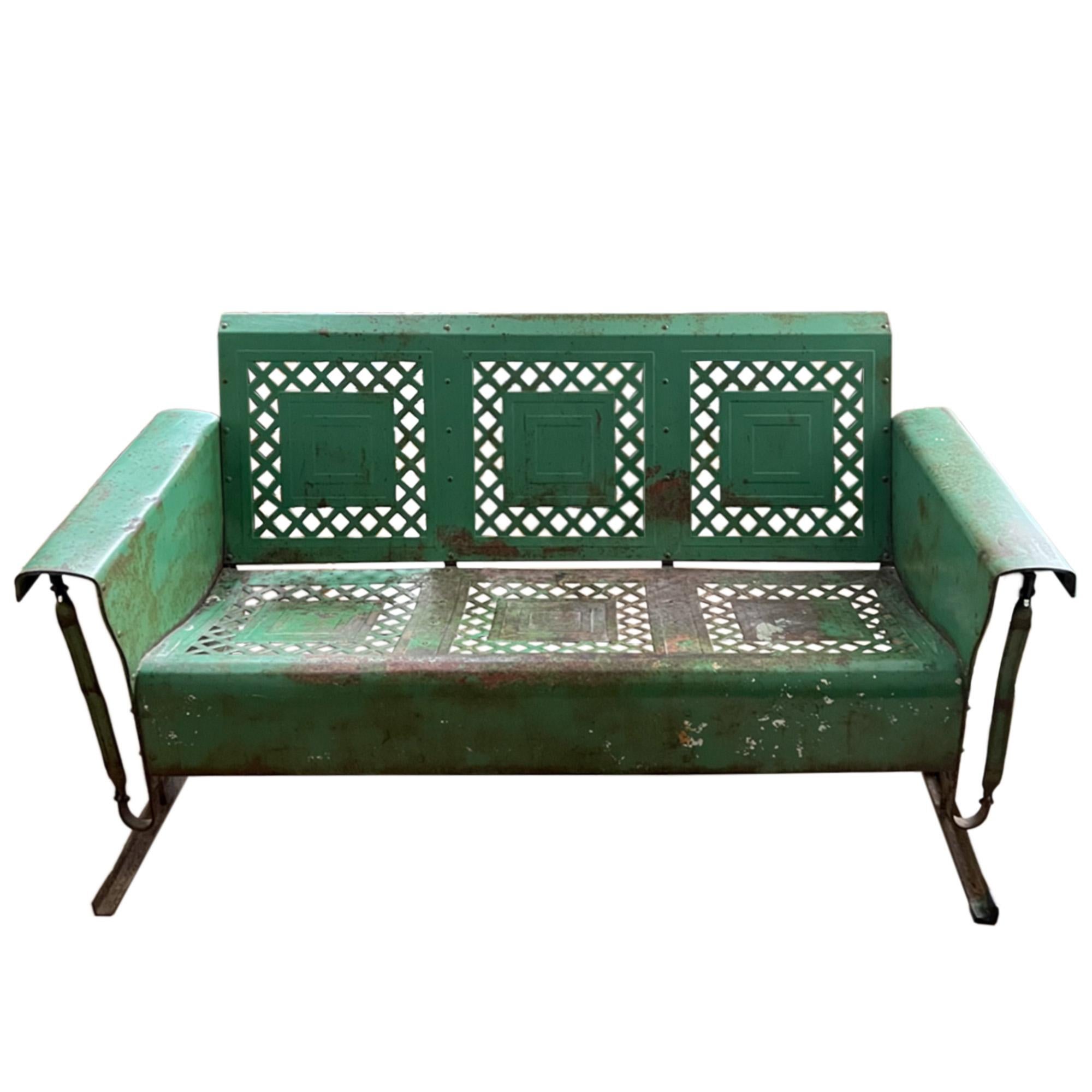 This modernist North American porch glider is made to a great design. A good, deep seat, high back and with a rocking mechanism. 

The original green paint has faded and worn as you would expect with use. It can be repainted if desired.

This piece