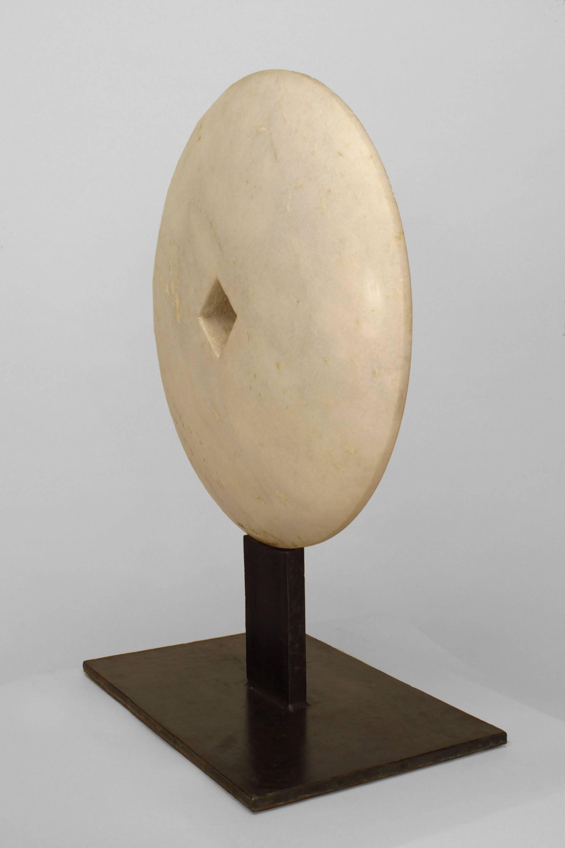 American Post-War Design style abstract sculpture of light grey marble disc with a cut-out square center mounted on a rectangular iron base. (modern)
