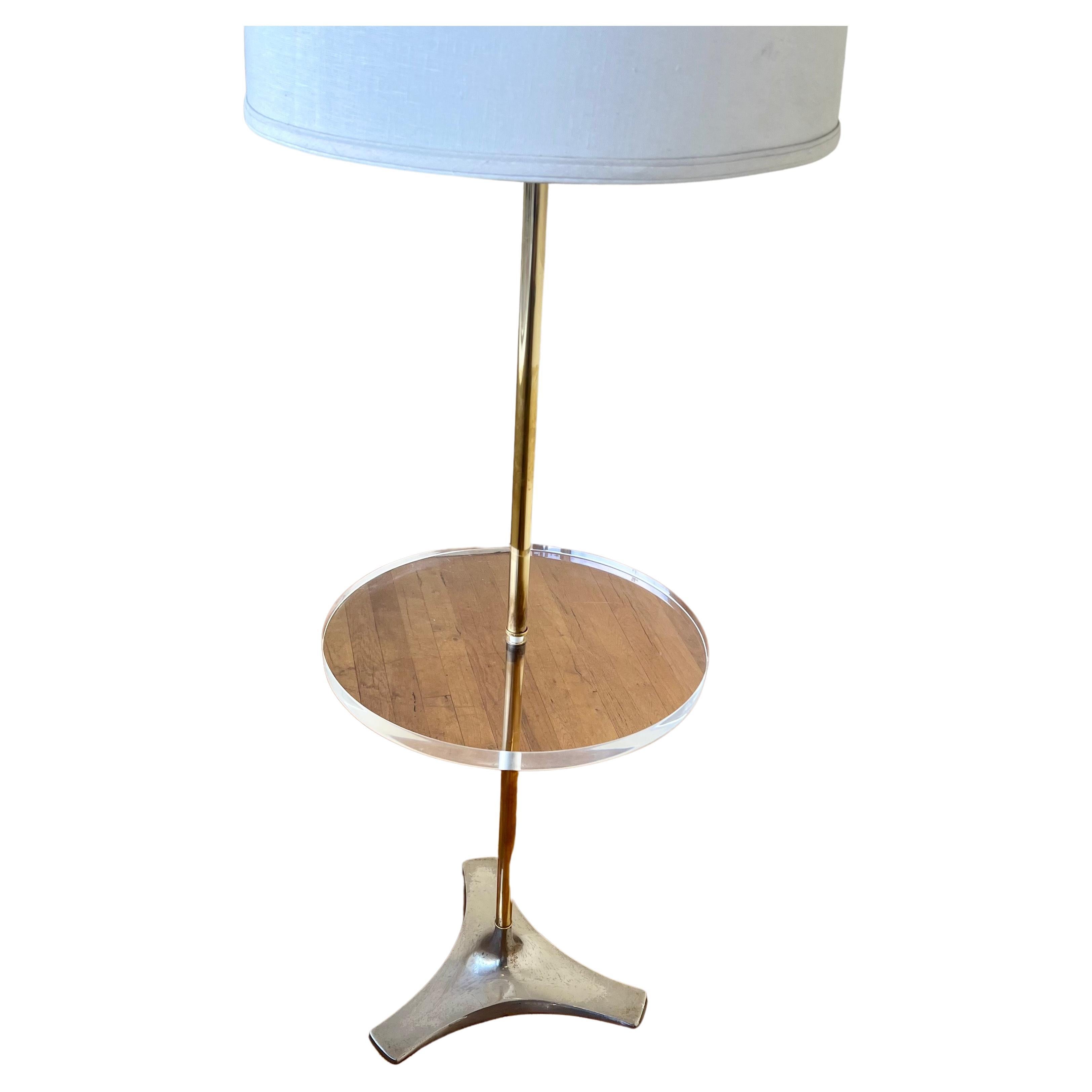 Beautiful elegant Table lamp by Laurel Lighting , circa 1970's brass polished poles with solid one inch thick lucite round top. we have this piece remade its been rewired and chrome star base, with a nice lampshade, nice condition beautiful and