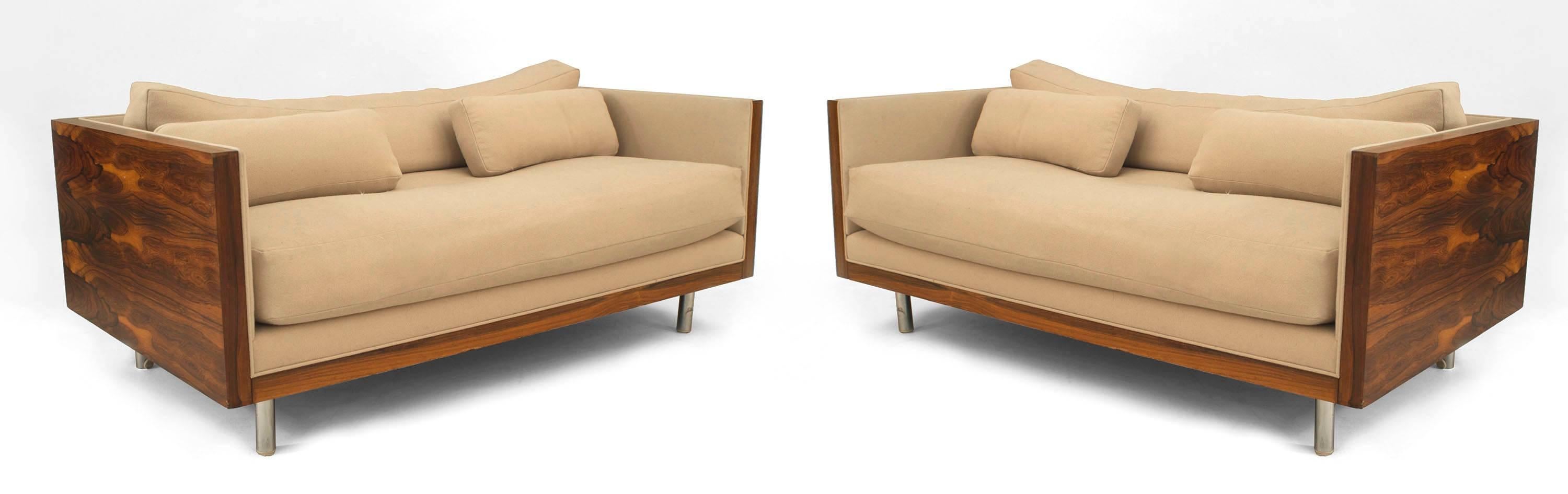 2 American Post-War design rosewood loveseats with chrome trim on cylindrical feet having light beige upholstery in the style of Milo Baughman (PRICED EACH)
