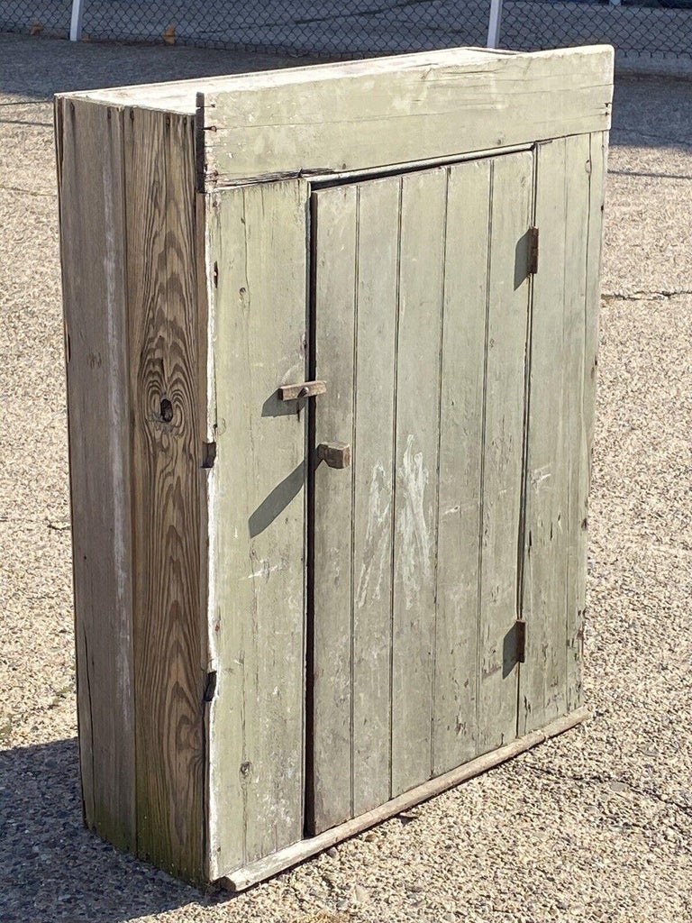 Antique American Primitive Country Colonial green distress painted wood cupboard pantry. Item features solid wood construction, distressed Green finish, 1 swing door, 3 wooden shelves. Circa 19th Century. Measurements: 48.5
