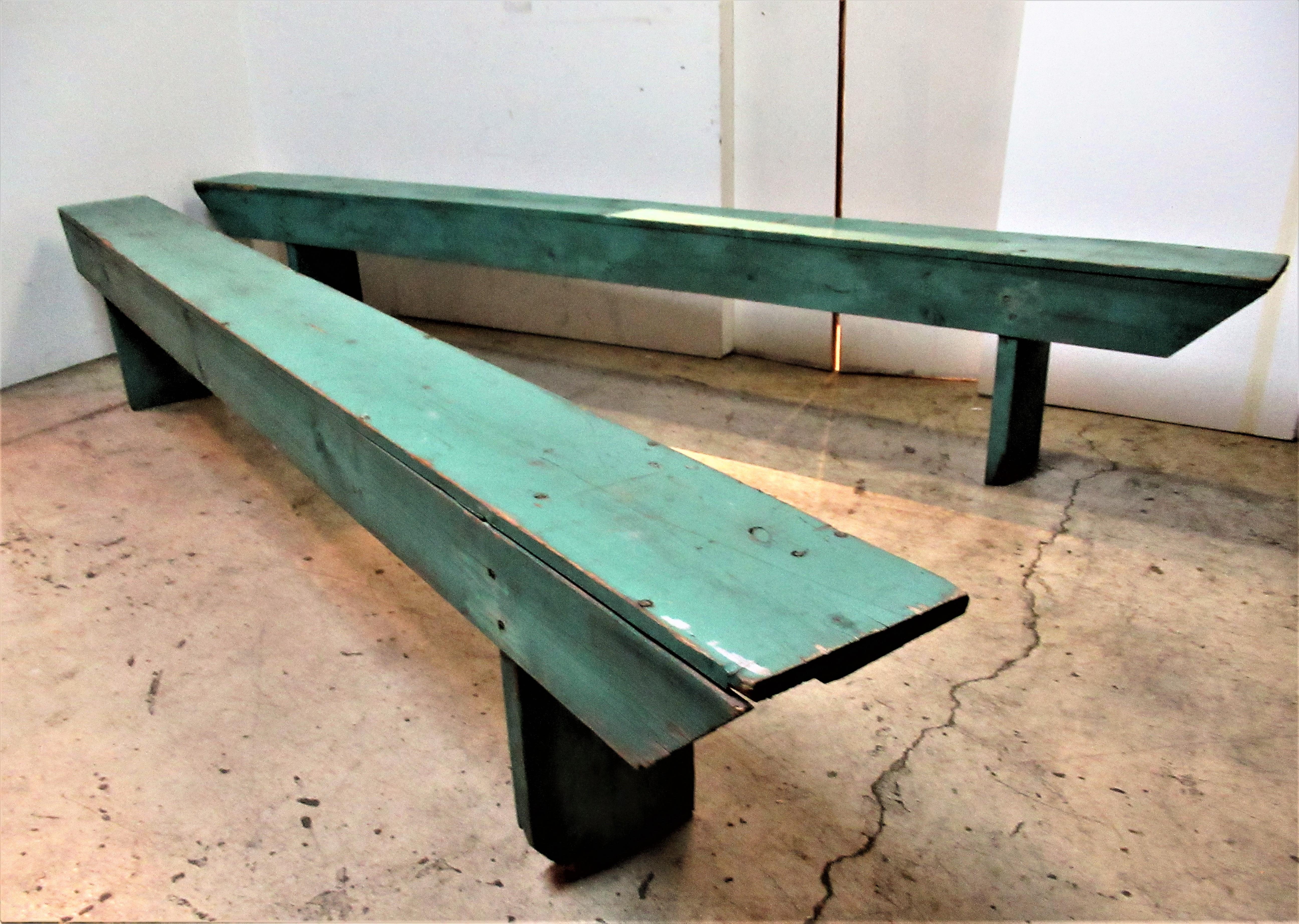 Pair of Primitive 10 foot long Minimalist form wood benches in the most beautifully aged original jewel tone dry green painted surface, American, circa 1940.