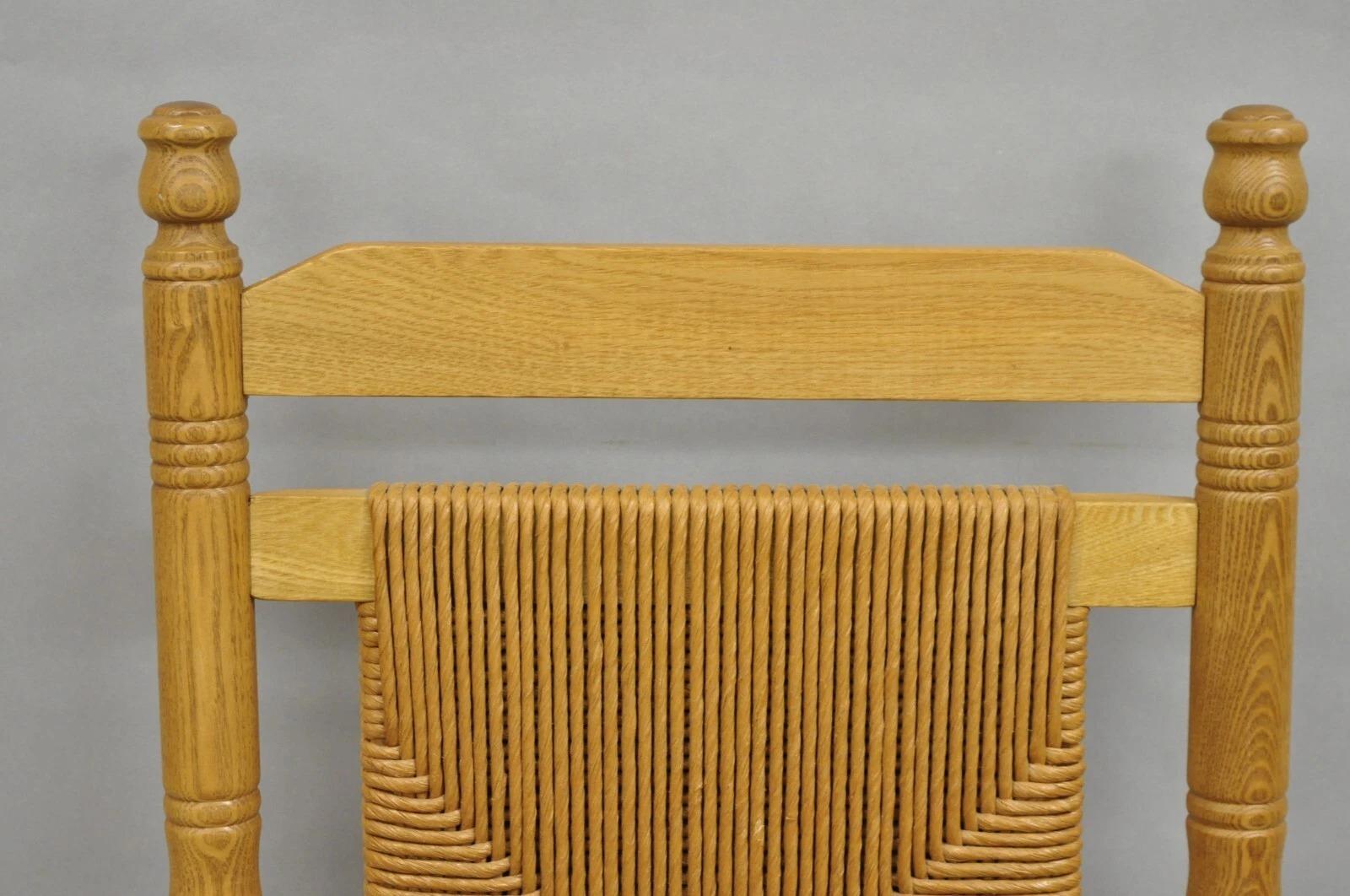 American Primitive Rustic Oak Wood Rush Seat Rocking Chair by Cracker Barrel In Good Condition For Sale In Philadelphia, PA