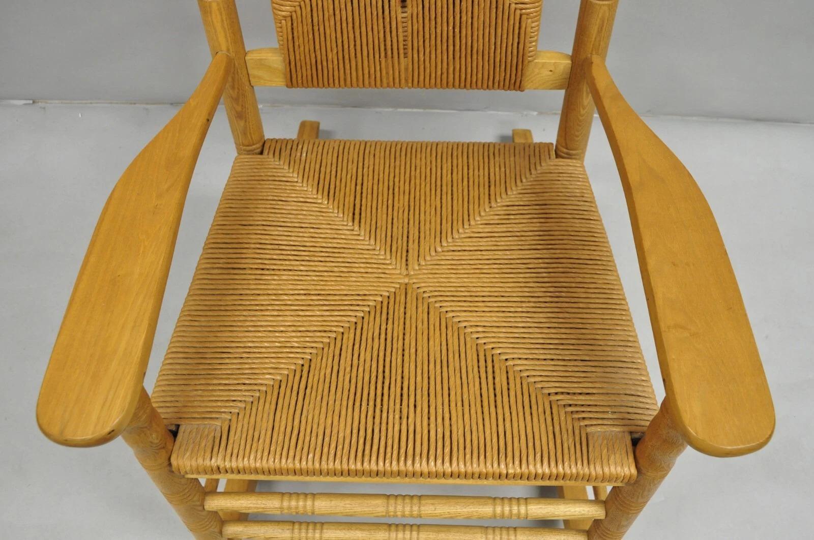 20th Century American Primitive Rustic Oak Wood Rush Seat Rocking Chair by Cracker Barrel For Sale