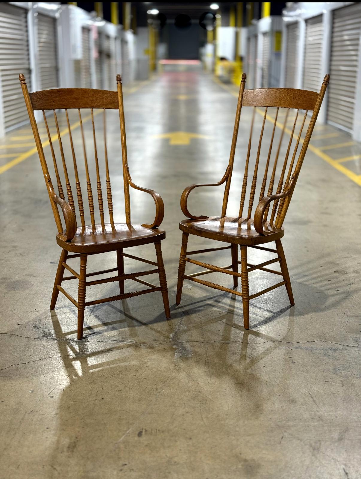 Beautiful pair of American Primitive Rustic chairs with spindle backs and curved arms.
In the Arts and Crats style, chairs like these are timeless and versatile. Use at a dining room table, fireside, bedroom sitting chairs or an occasional